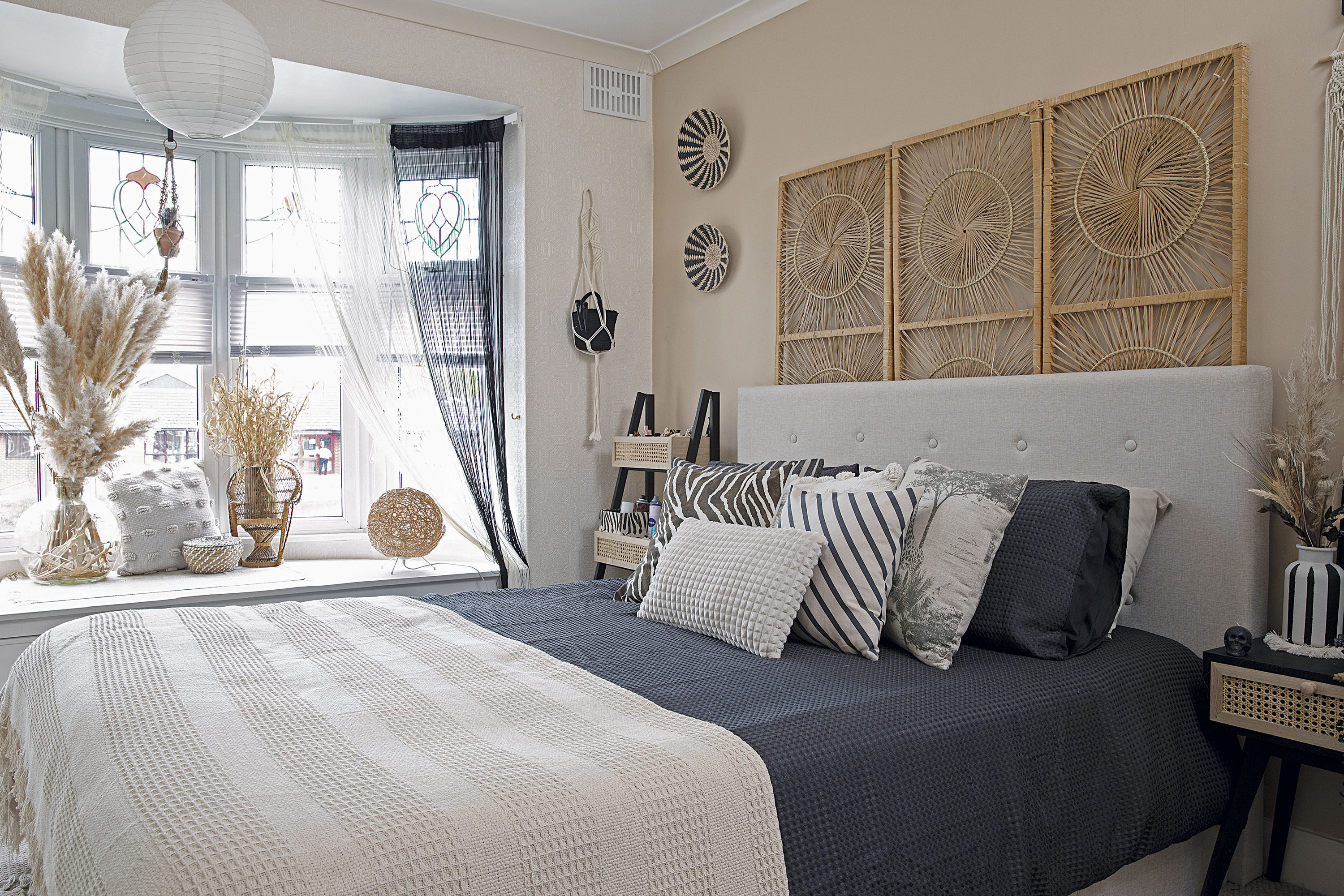 The rattan screen, a gift from a friend, makes a striking focal point behind the headboard. Dunelm has a similar design for £75. Handy storage in the deep bay window sill has proved invaluable, and Leanne loves having another spot for displaying her vases. She has added black and white fringe curtains to give a 70s vibe The rattan screen, a gift from a friend, makes a striking focal point behind the headboard. Dunelm has a similar design for £75. Handy storage in the deep bay window sill has proved invaluable, and Leanne loves having another spot for displaying her vases. She has added black and white fringe curtains to give a 70s vibe