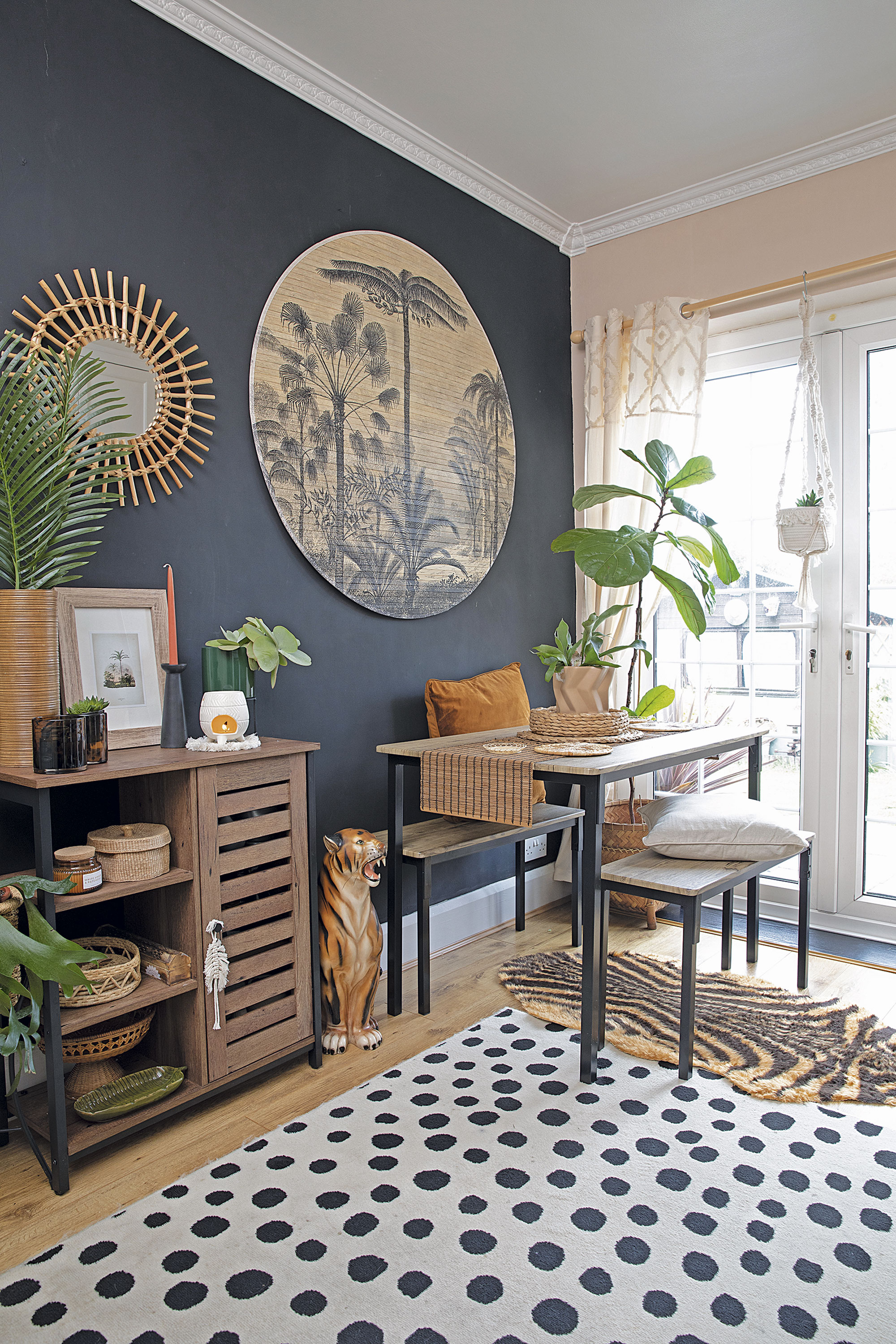 A black feature wall provides the perfect backdrop for Leanne’s forest wall hanging from Love Frankie and storage unit from Vasagle, while the compact dining table with benches from Argos is a real space saver. ‘The spotty rug from George Home was originally for the bedroom but it was much larger than I thought so it would only fit down here,’ adds Leanne A black feature wall provides the perfect backdrop for Leanne’s forest wall hanging from Love Frankie and storage unit from Vasagle, while the compact dining table with benches from Argos is a real space saver. ‘The spotty rug from George Home was originally for the bedroom but it was much larger than I thought so it would only fit down here,’ adds Leanne