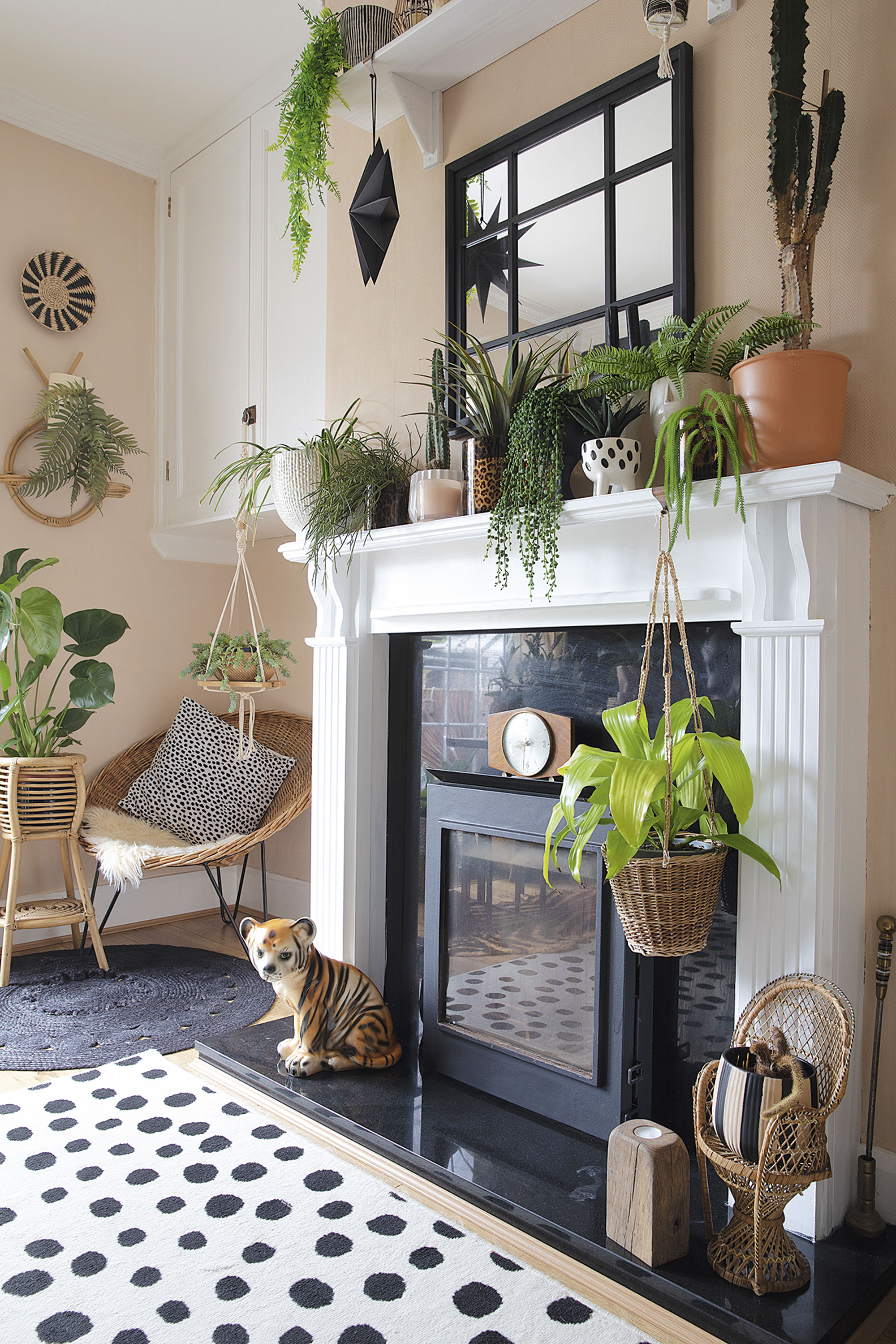 ‘I painted the wooden fire surround black to start with, but it looks miles better white, as it makes the plants stand out more,’ says Leanne. The Crittall- style mirror is from Home Bargains and the walls are painted in Johnstone’s Oatcake ‘I painted the wooden fire surround black to start with, but it looks miles better white, as it makes the plants stand out more,’ says Leanne. The Crittall- style mirror is from Home Bargains and the walls are painted in Johnstone’s Oatcake