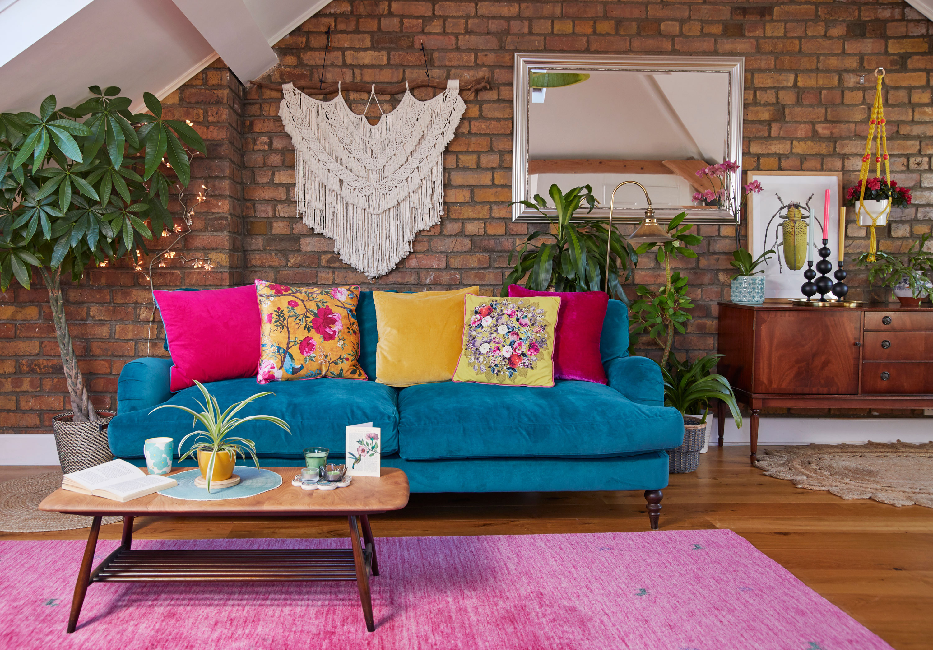 Emma made the macramé hanging, and found the brass lamp on the street. It doesn’t work, but she loves the look of it. The rug, from Rug Vista, is the same pink as her wedding shoes; one of the many personal touches she’s added Living room makeover: 'My multi-use room sings with colour'