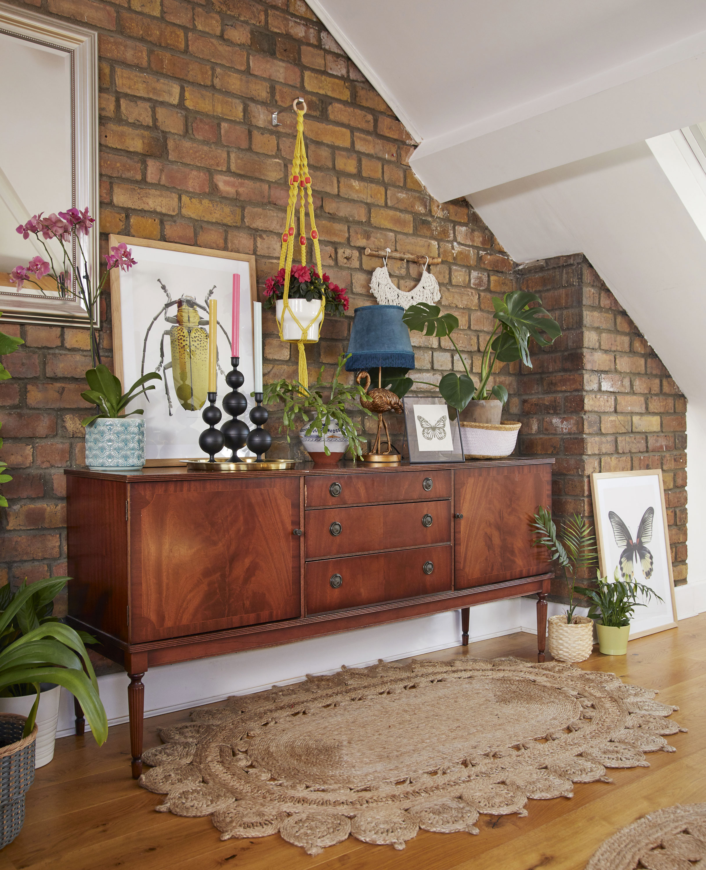 Emma is always looking for interesting, vintage finds, including the sideboard she bought in a charity shop for £45. She’s styled it with insect motifs to reflect her passion for the natural world Living room makeover: 'My multi-use room sings with colour'