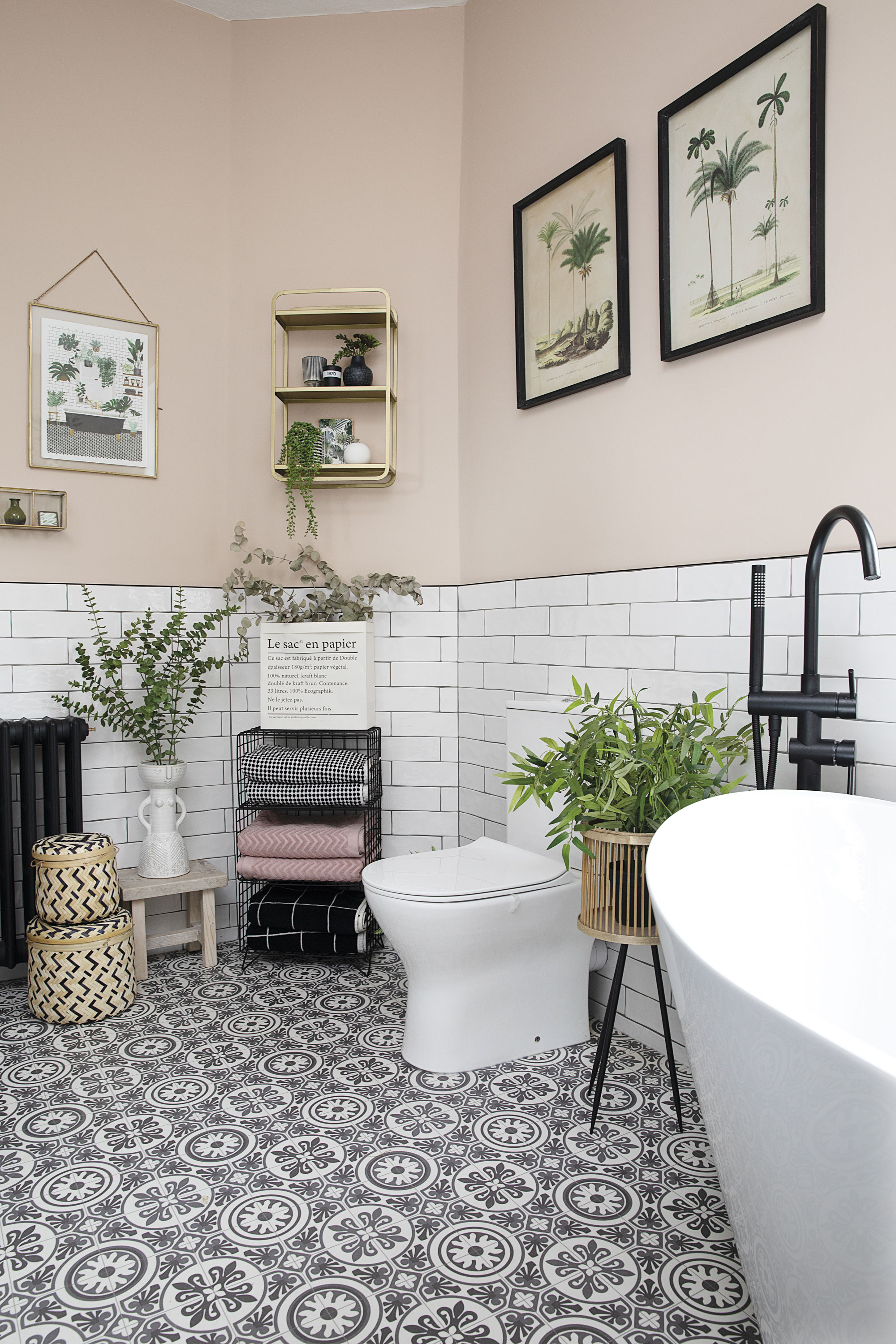 Although they toyed with putting the vanity unit in this angled corner, the couple felt it would work better on the opposite wall. Instead, they’ve moved the toilet further away from the bath and added a black mesh rack for storing towels Although they toyed with putting the vanity unit in this angled corner, the couple felt it would work better on the opposite wall. Instead, they’ve moved the toilet further away from the bath and added a black mesh rack for storing towels