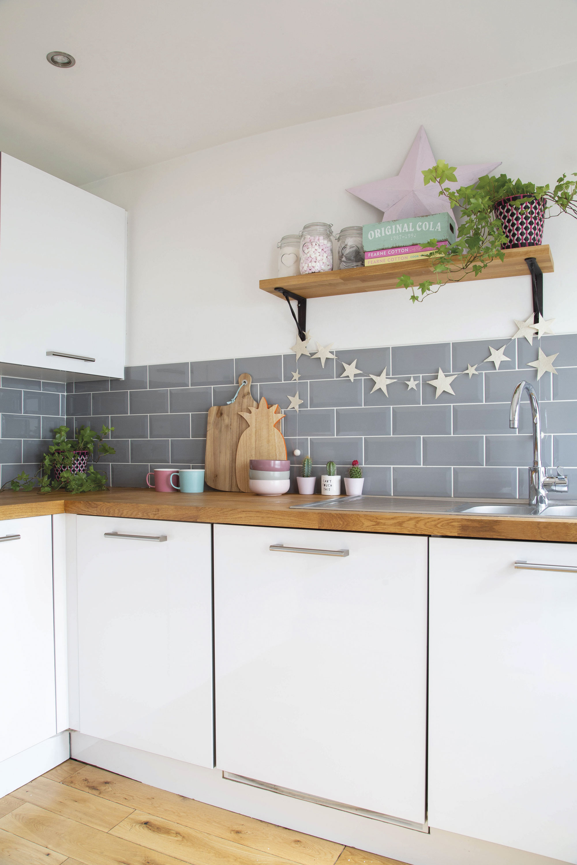 The original, behind-the-times kitchen was hastily removed the day the couple moved in to allow room for their appliances. In its place, they fitted simple, unfussy units and low-cost tiles to, once again, allow artwork to take centre stage The original, behind-the-times kitchen was hastily removed the day the couple moved in to allow room for their appliances. In its place, they fitted simple, unfussy units and low-cost tiles to, once again, allow artwork to take centre stage