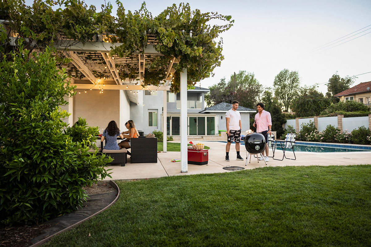 Wide view of friends enjoying party at vacation rental