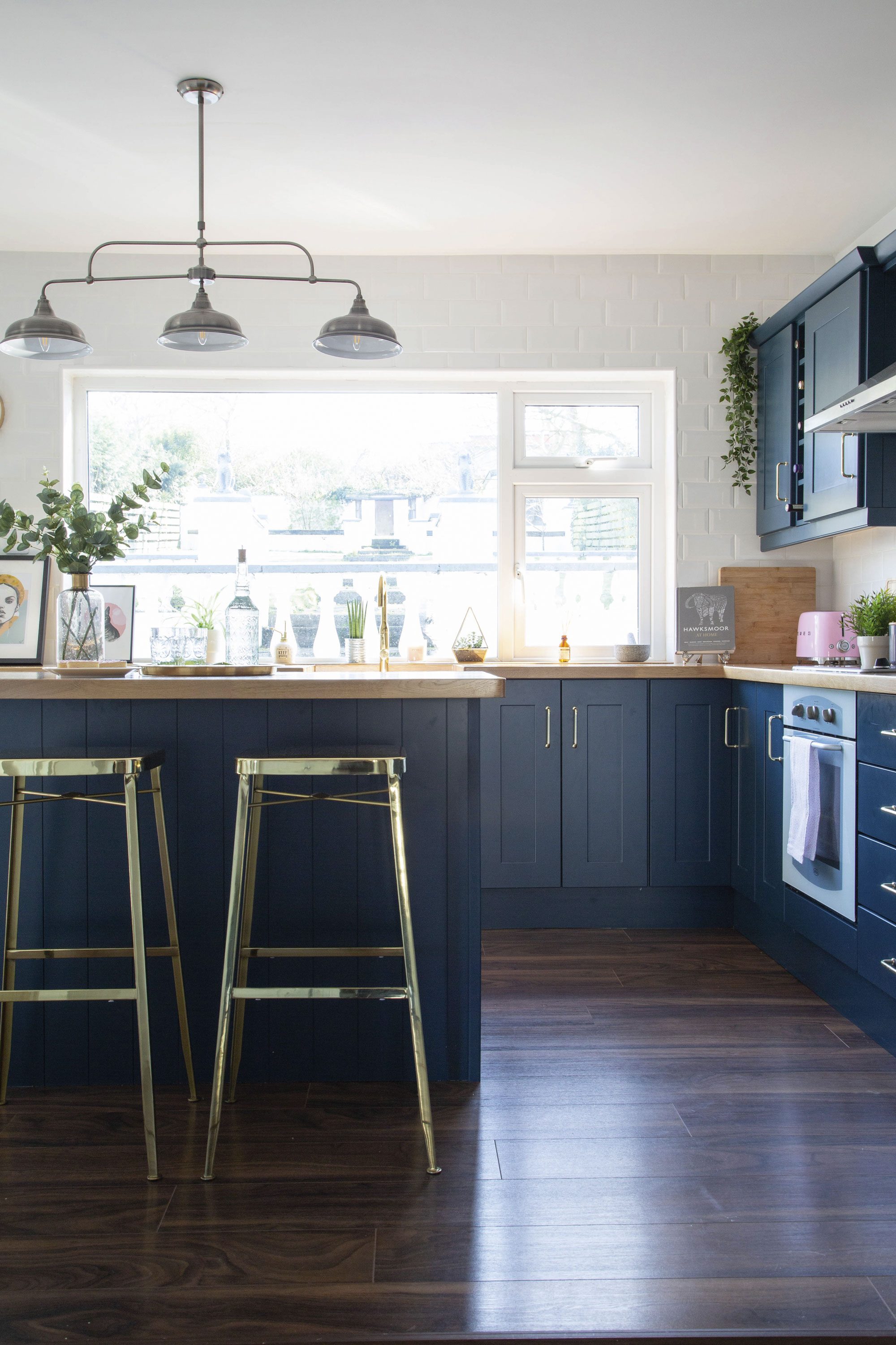 ‘We had originally planned to only replace the countertops and spray the kitchen cabinets to keep costs down, but our carpenter advised us to get new cupboard doors, too,’ Lynn says. ‘We kept the carcasses in place and chose new Shaker-style doors in Farrow & Ball’s Hague Blue, plus a solid oak worktop’ ‘We had originally planned to only replace the countertops and spray the kitchen cabinets to keep costs down, but our carpenter advised us to get new cupboard doors, too,’ Lynn says. ‘We kept the carcasses in place and chose new Shaker-style doors in Farrow & Ball’s Hague Blue, plus a solid oak worktop’