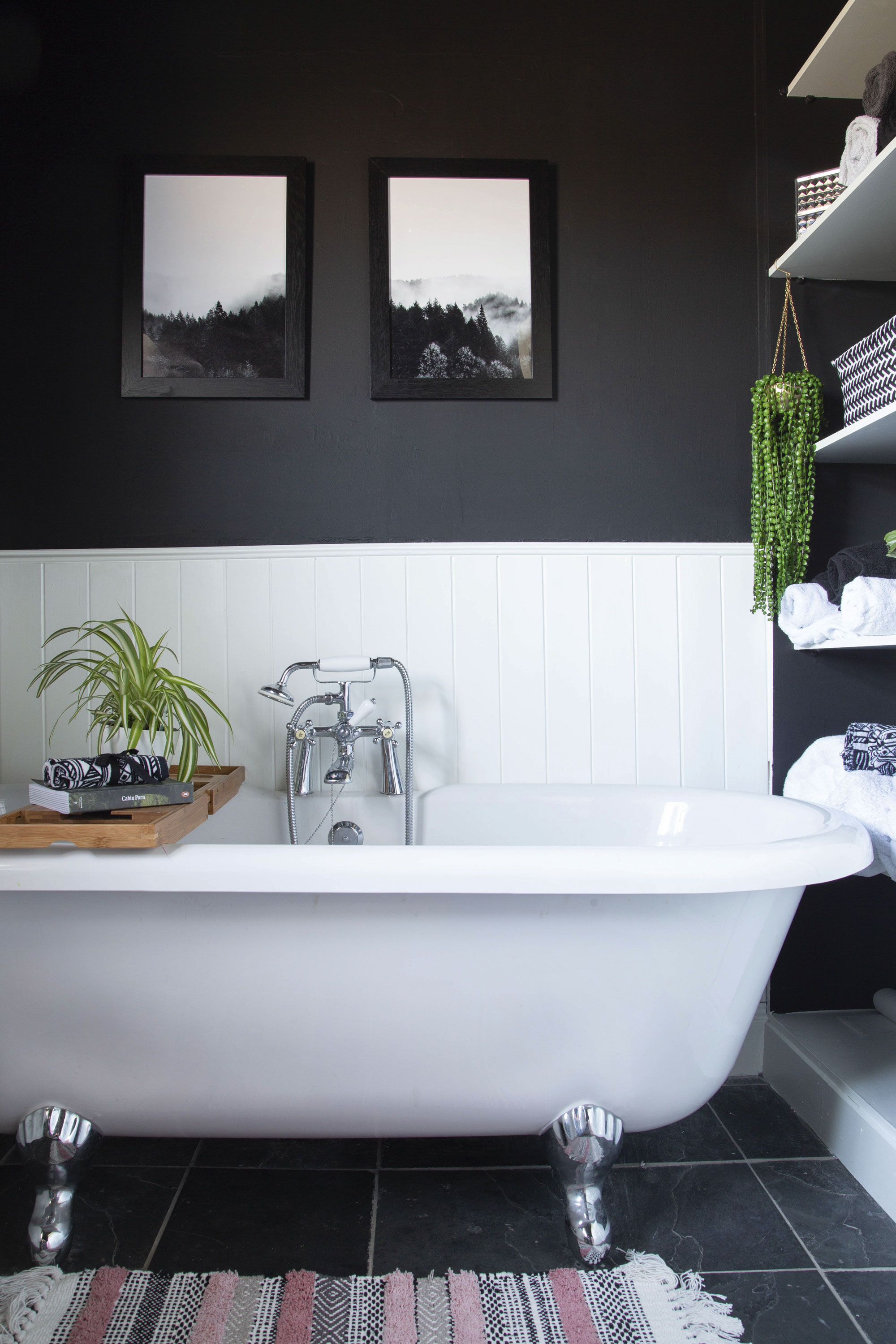 ‘The bathroom was in pretty good shape, and came with a beautiful free-standing bath,’ Lynn says. ‘We painted the bottom half of the walls white and the top half and ceiling black, which provides the illusion of increased space in the room’ ‘The bathroom was in pretty good shape, and came with a beautiful free-standing bath,’ Lynn says. ‘We painted the bottom half of the walls white and the top half and ceiling black, which provides the illusion of increased space in the room’