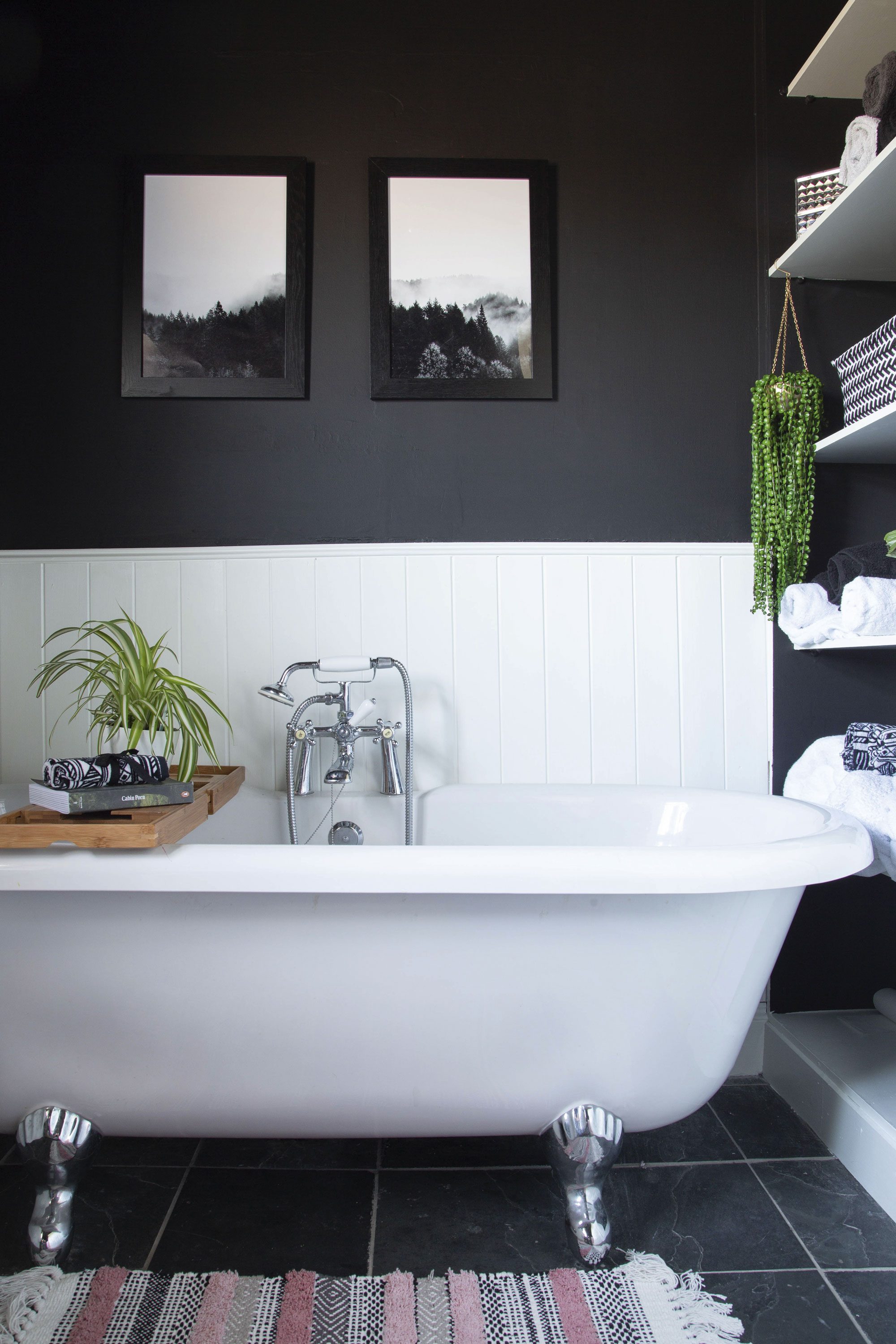 ‘The bathroom was in pretty good shape, and came with a beautiful free-standing bath,’ Lynn says. ‘We painted the bottom half of the walls white and the top half and ceiling black, which provides the illusion of increased space in the room’ ‘The bathroom was in pretty good shape, and came with a beautiful free-standing bath,’ Lynn says. ‘We painted the bottom half of the walls white and the top half and ceiling black, which provides the illusion of increased space in the room’