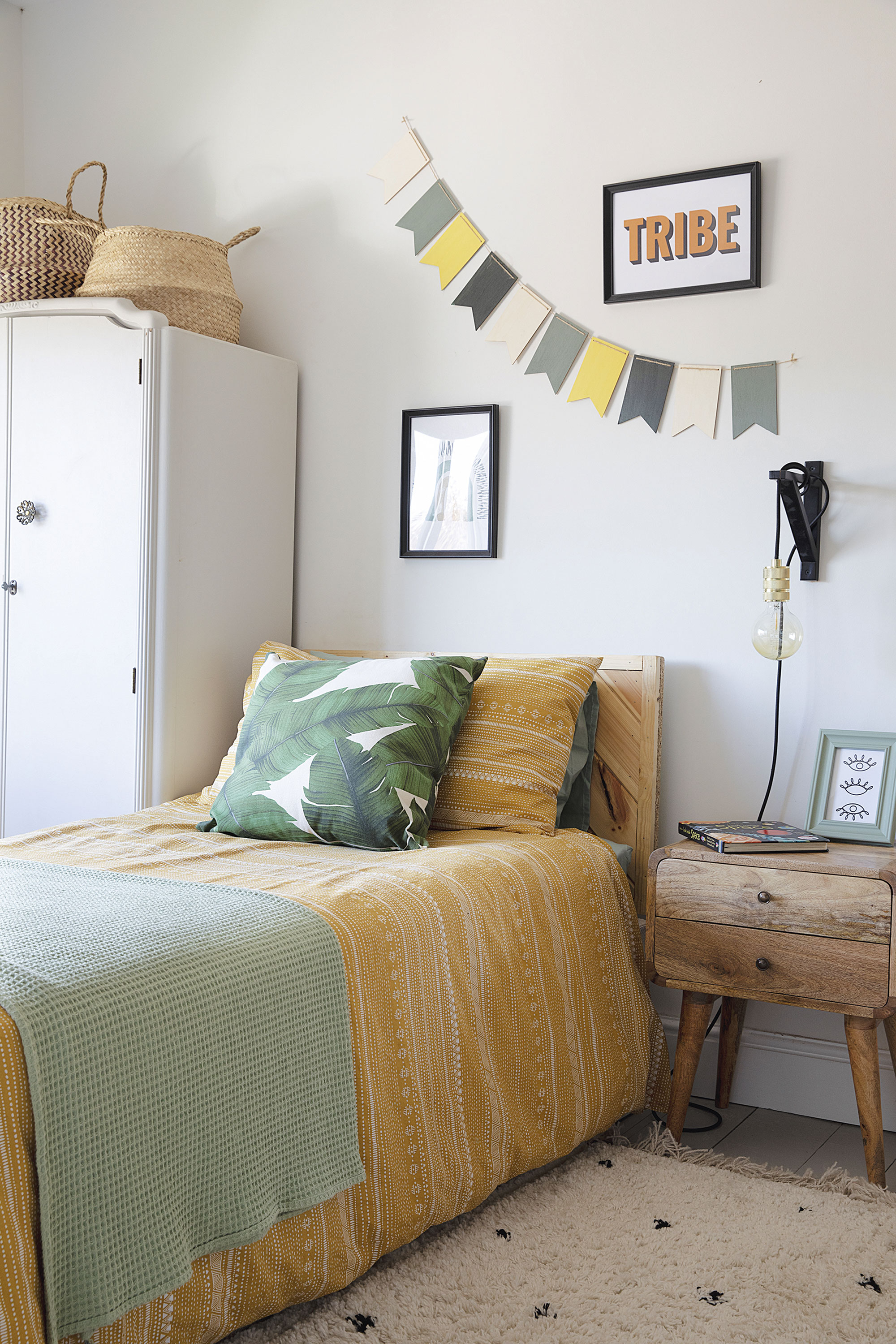 Mustard bedding and a palm leaf cushion from H&M Home complement the jungle wallpaper. Laura upcycled the second-hand wardrobe and made the bunting herself Mustard bedding and a palm leaf cushion from H&M Home complement the jungle wallpaper. Laura upcycled the second-hand wardrobe and made the bunting herself