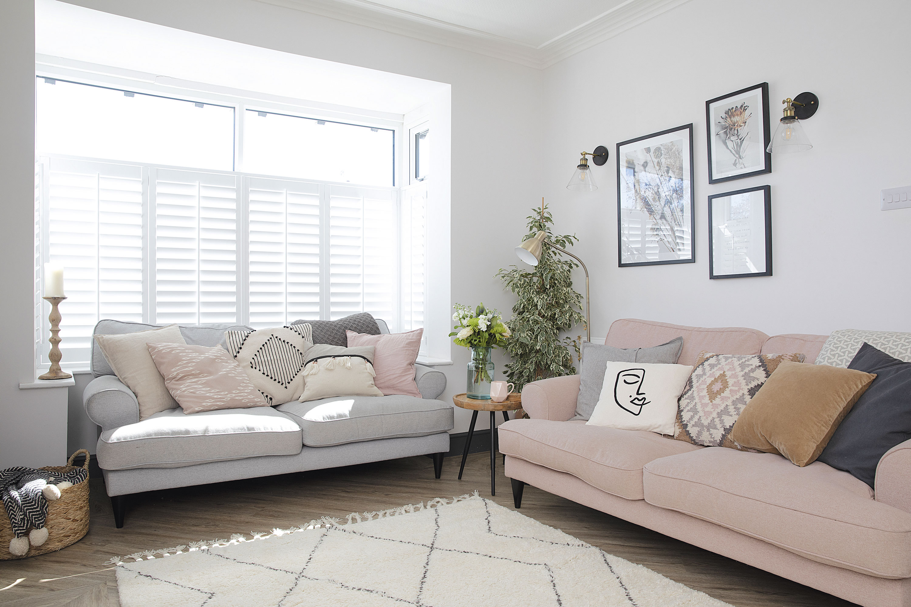 ‘Most of my cushions are from H&M Home as they’re great value and have loads of designs,’ says Laura. ‘I like mixing large block coloured cushions and a handful of boho and Scandi statement cushions at the front to create balance and interest. The artwork from Juniqe reflects my love of dried flowers and is framed by wall lights from Iconic Lights’ ‘Most of my cushions are from H&M Home as they’re great value and have loads of designs,’ says Laura. ‘I like mixing large block coloured cushions and a handful of boho and Scandi statement cushions at the front to create balance and interest. The artwork from Juniqe reflects my love of dried flowers and is framed by wall lights from Iconic Lights’