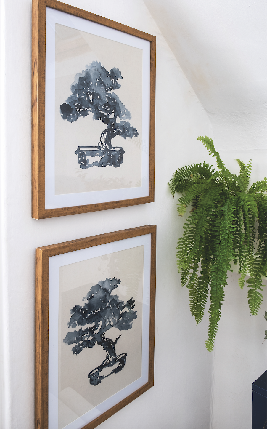 Add art to make a bathroom feel more homely. Sylwia chose a pair of prints that tie in with the navy blue sink and toilet unit