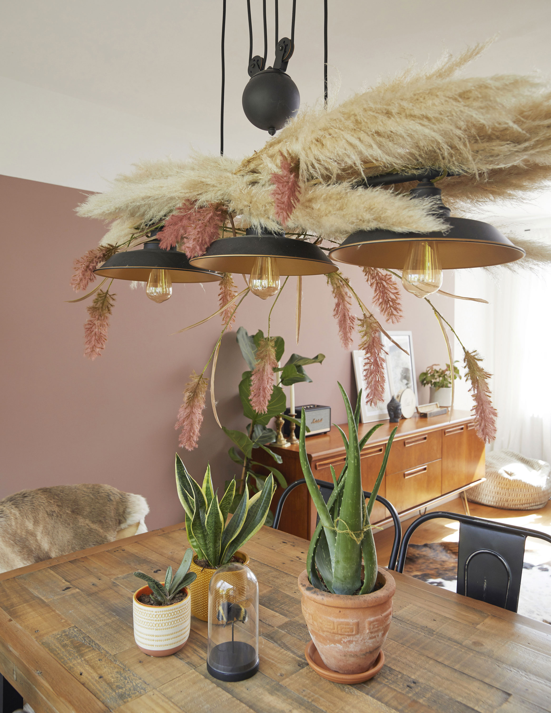 ‘I love this effect of dried flowers and pampas grass hung from the ceiling. I’d seen the look online when researching for my wedding but used it here instead. It was easy to do – I pushed the foliage through the slots on the light – but it looks so effective’