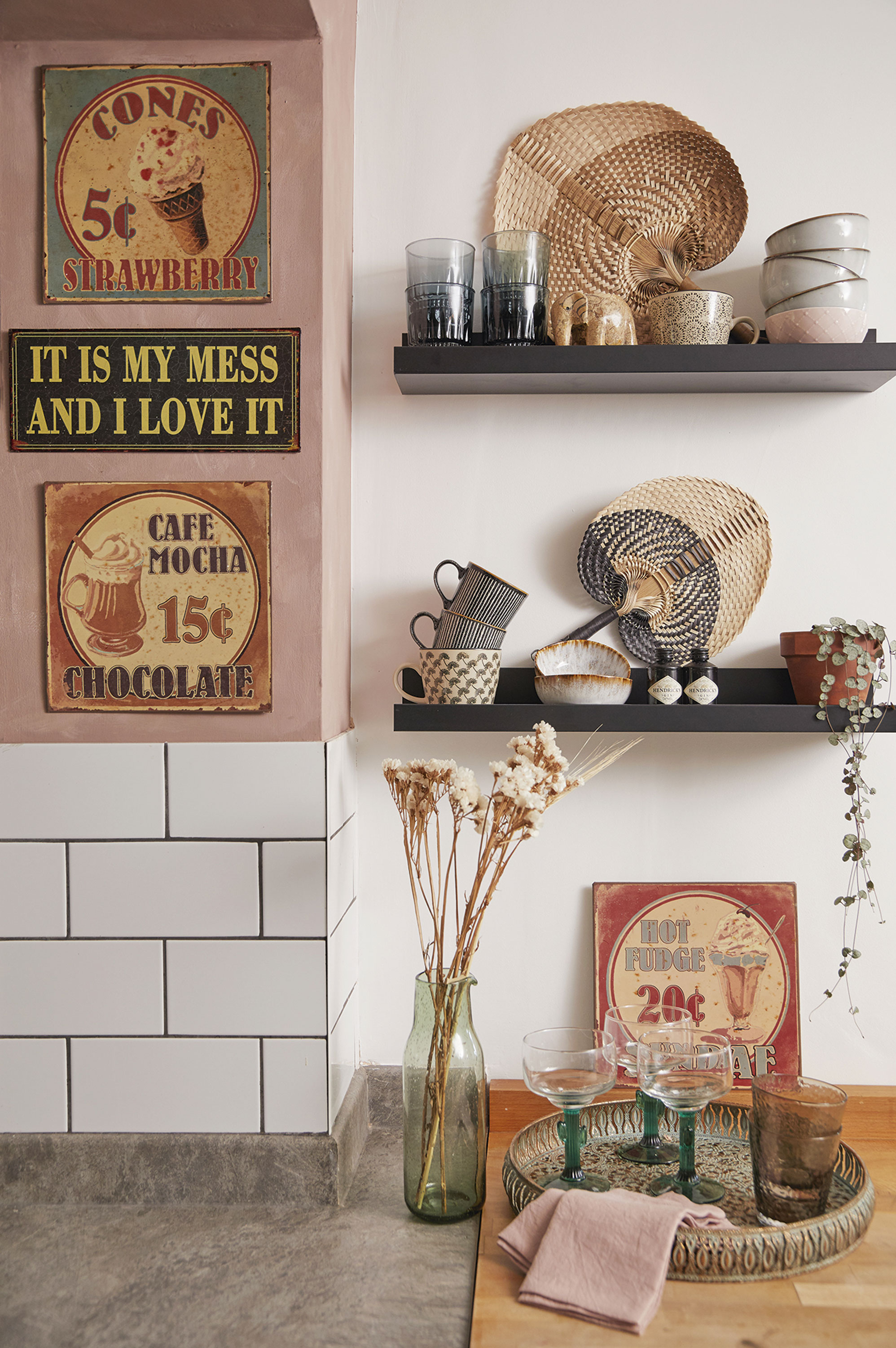 ‘The black shelves are actually picture ledges, but they are a handy size for storing cups and bowls. I’ve had these metal signs for years and although they’re replicas, I love their vintage vibe’