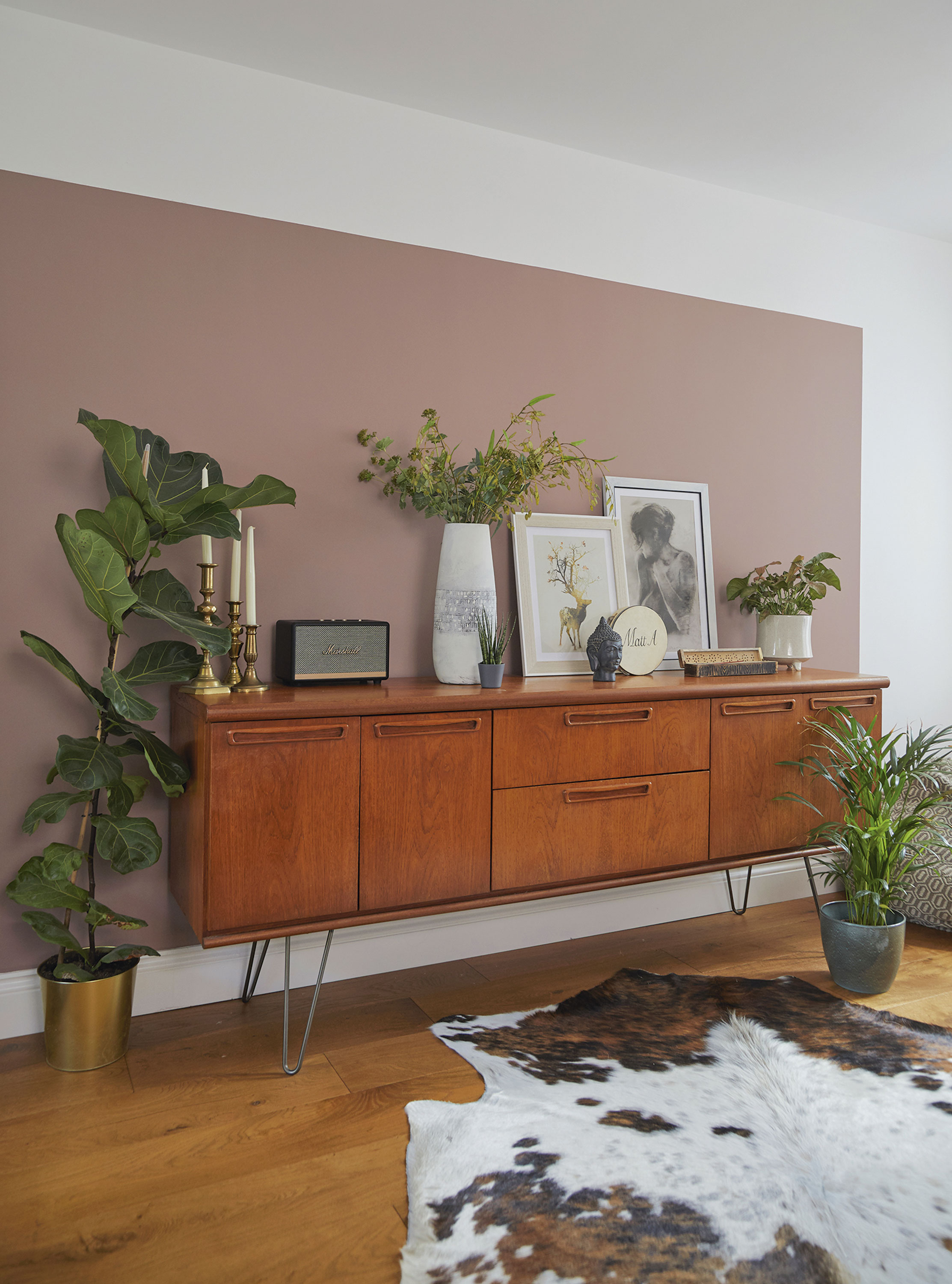 ‘The prints on this cabinet get swapped about a lot and the vase was originally silver. I covered it with a whitewash to update it and I fill it with fake flowers ‘