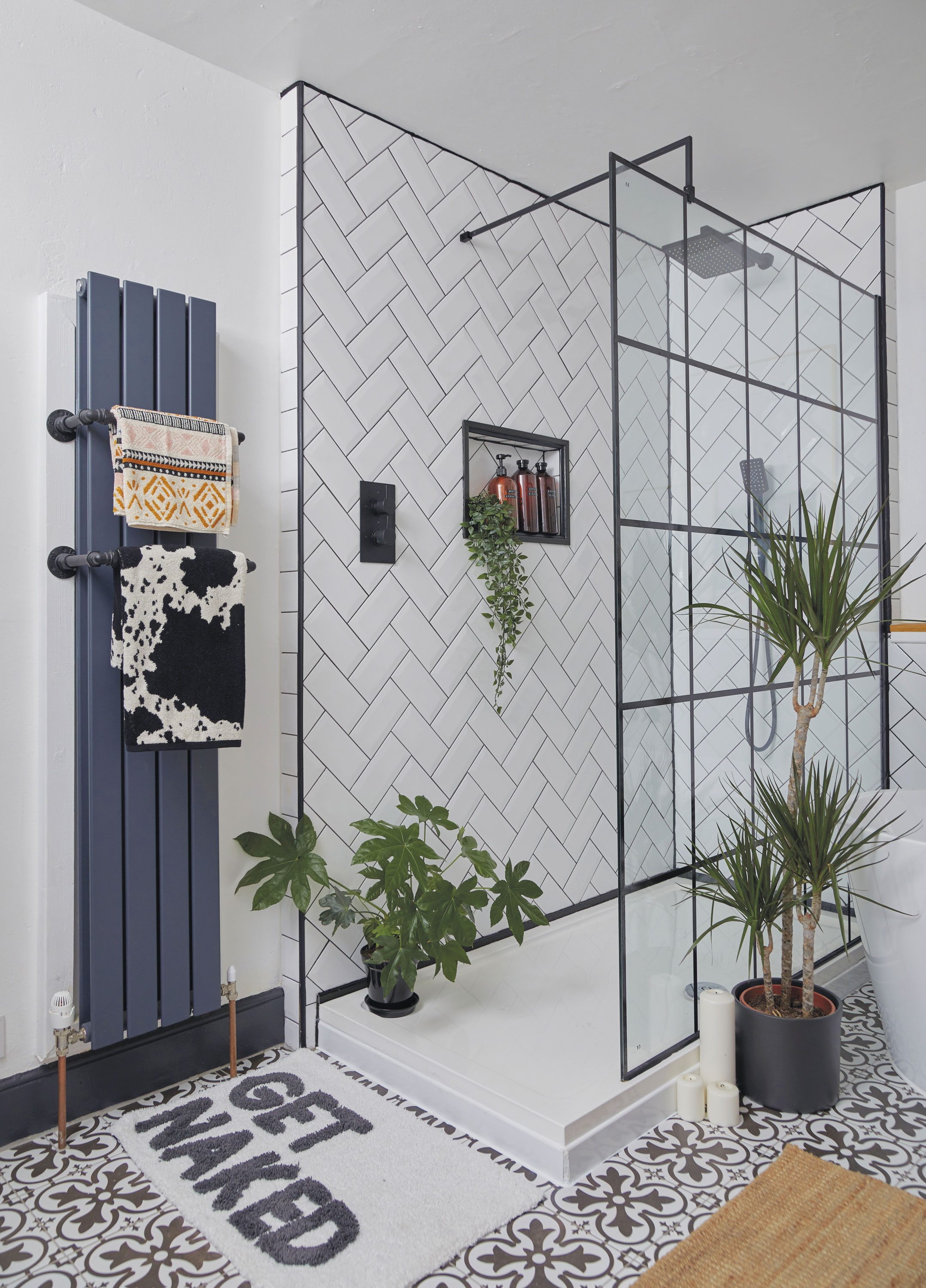 ‘The small radiator towel rails are made from copper pipe and elbows that we simply fitted together and sprayed black,’ says Ennli. The recessed shelf is a clever design feature perfect for storing the couple’s shower products ‘The small radiator towel rails are made from copper pipe and elbows that we simply fitted together and sprayed black,’ says Ennli. The recessed shelf is a clever design feature perfect for storing the couple’s shower products