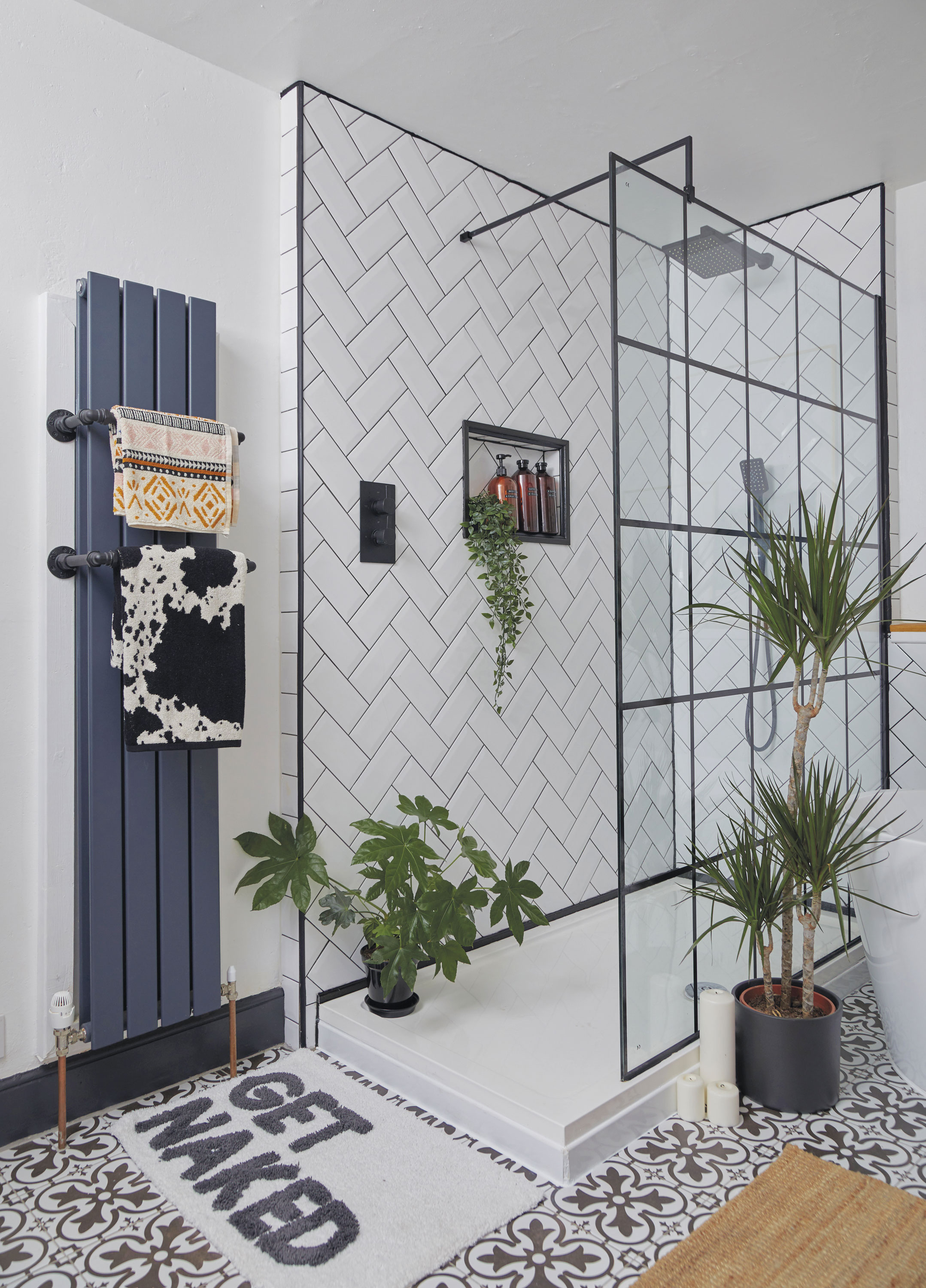 ‘The small radiator towel rails are made from copper pipe and elbows that we simply fitted together and sprayed black,’ says Ennli. The recessed shelf is a clever design feature perfect for storing the couple’s shower products ‘The small radiator towel rails are made from copper pipe and elbows that we simply fitted together and sprayed black,’ says Ennli. The recessed shelf is a clever design feature perfect for storing the couple’s shower products