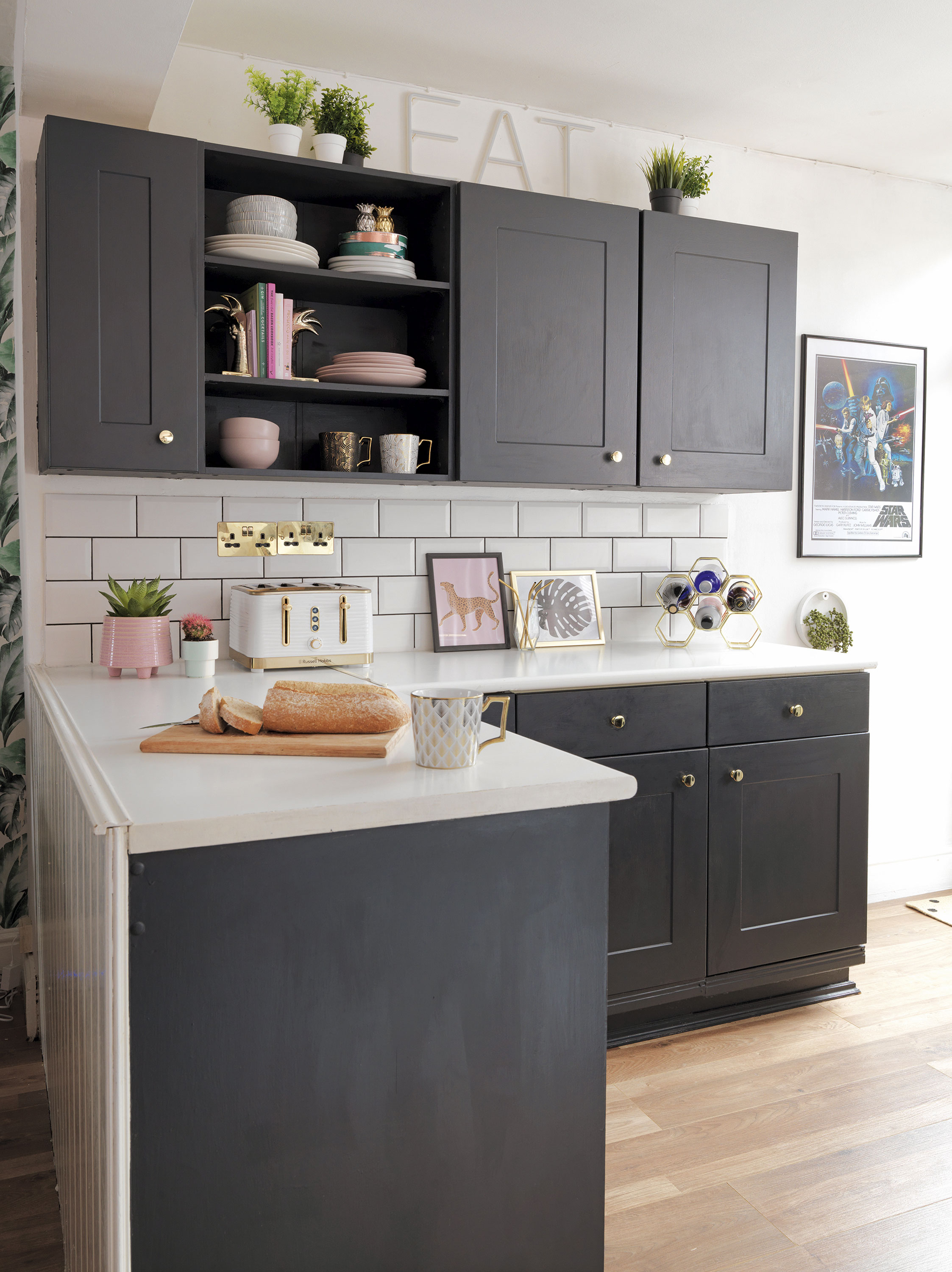 'Our home is cool & quirky with a bit of edge' Black painted cabinets in the kitchen have been given a more feminine flourish with pale pink crockery and accessories. The Star Wars print was Aaron’s choice – ‘it’s quite possibly his favourite part of the house,’ laughs Raya