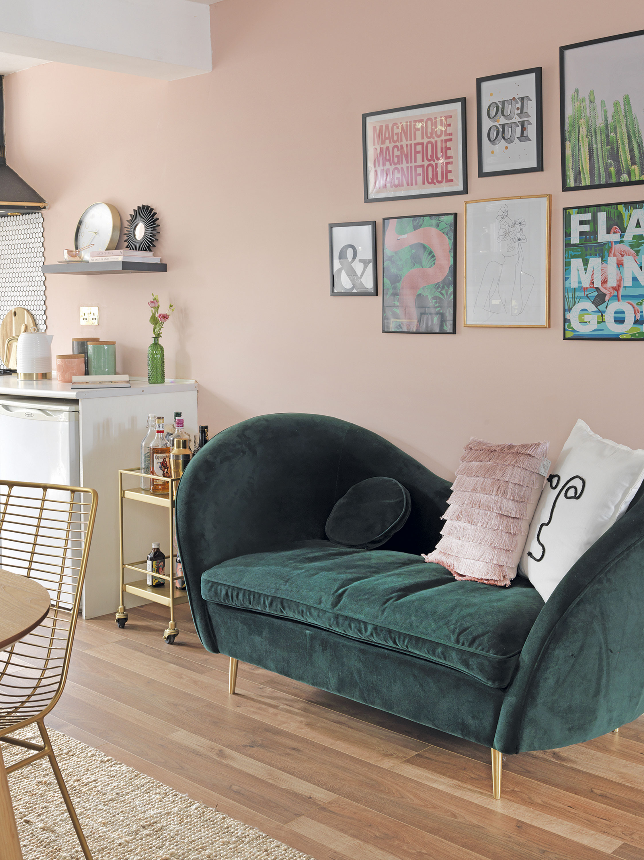 'Our home is cool & quirky with a bit of edge' Opposite the dining table, a compact velvet sofa from MADE.com sits underneath a selection of fun framed prints and quotes. ‘I’ve gone for a dark green and blush pink scheme with gold and brass accents,’ says Raya. ‘The drinks trolley next to the sofa gets pulled out when friends are round, but it’s small enough not to get in the way’