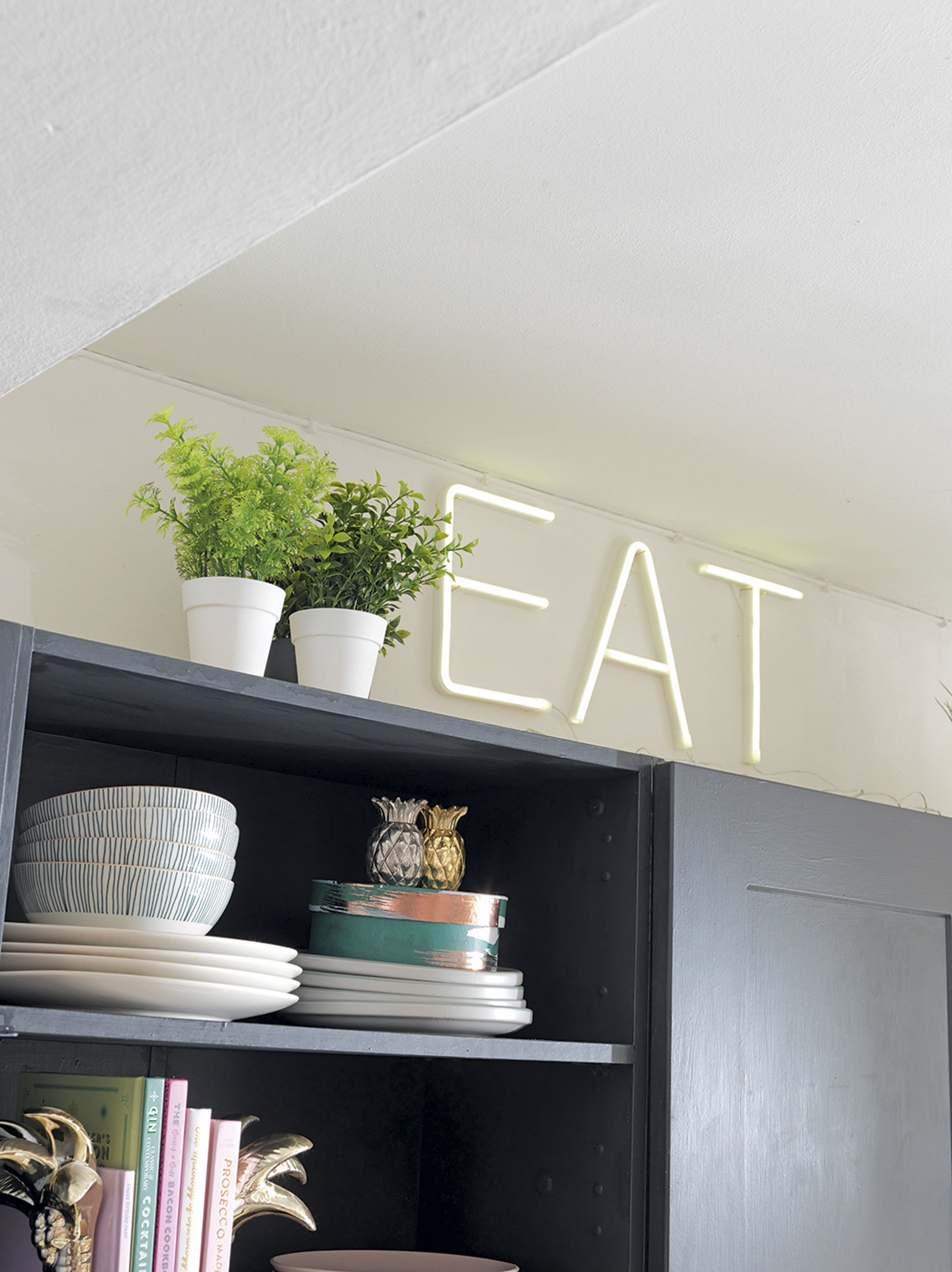 'Our home is cool & quirky with a bit of edge' ‘The LED ‘EAT’ sign is from Home Bargains. We bought the letters individually, so you can spell out any word. They add a bit of fun to the kitchen’