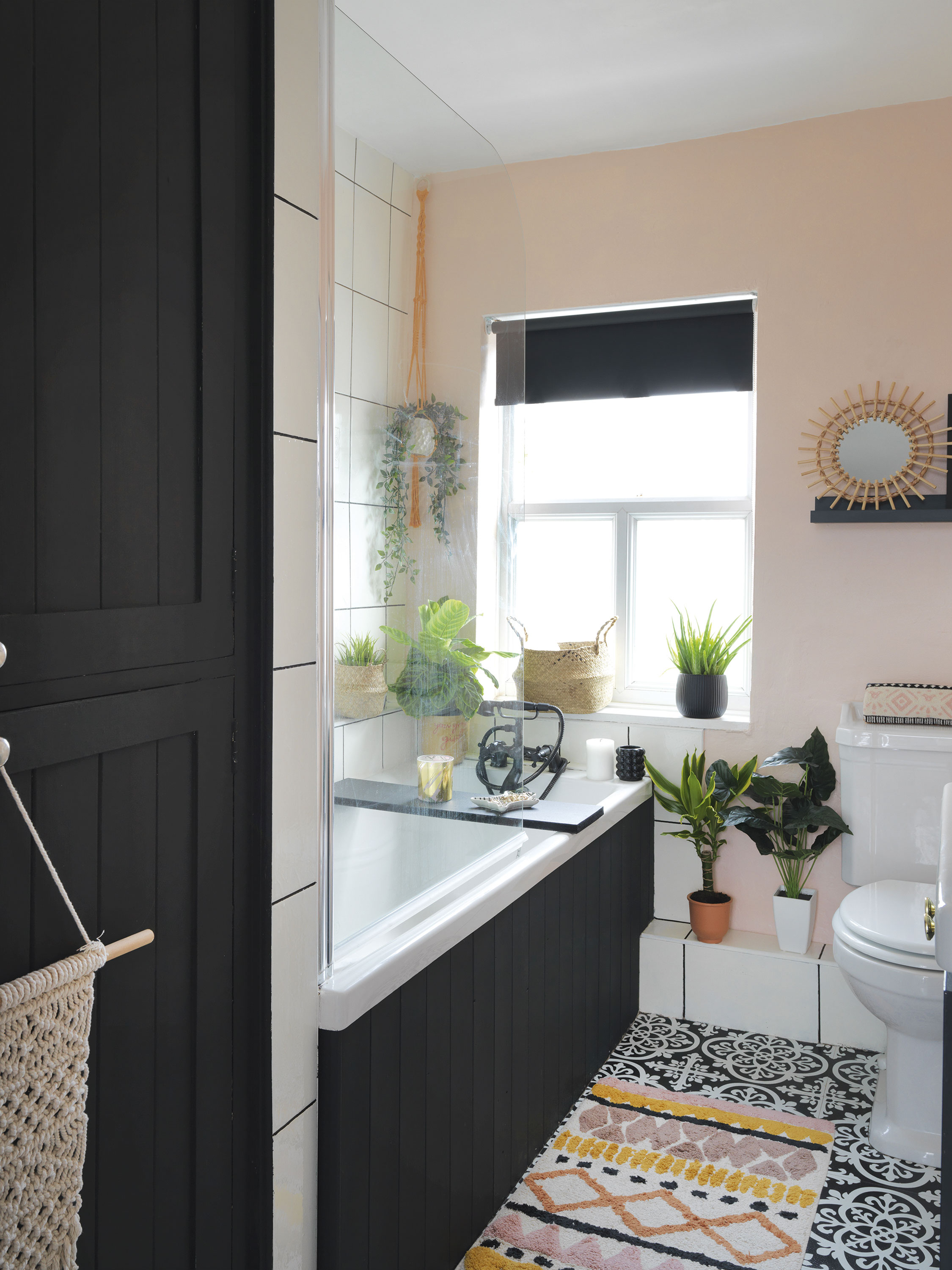 'Our home is cool & quirky with a bit of edge' Raya believes you can never have too many plants and mixes real with faux in every room, including the bathroom. The peel-and-stick bath tiles are from Wayfair and the bath mat is from George Home