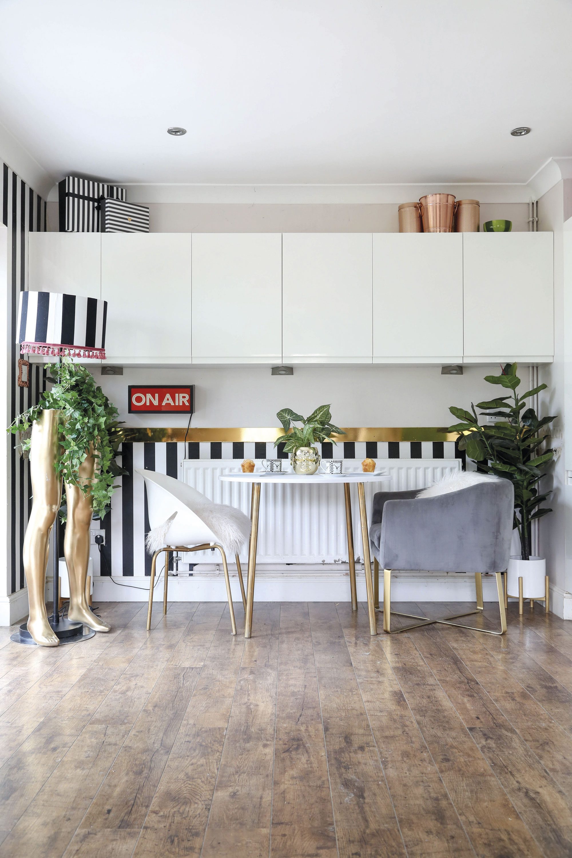 ‘I found the mannequin legs in a junkyard and decided to spray-paint them gold to create a fun feature,’ says Hayley. ‘The striped monochrome wallpaper was a bargain buy from Wilko’ ‘I found the mannequin legs in a junkyard and decided to spray-paint them gold to create a fun feature,’ says Hayley. ‘The striped monochrome wallpaper was a bargain buy from Wilko’