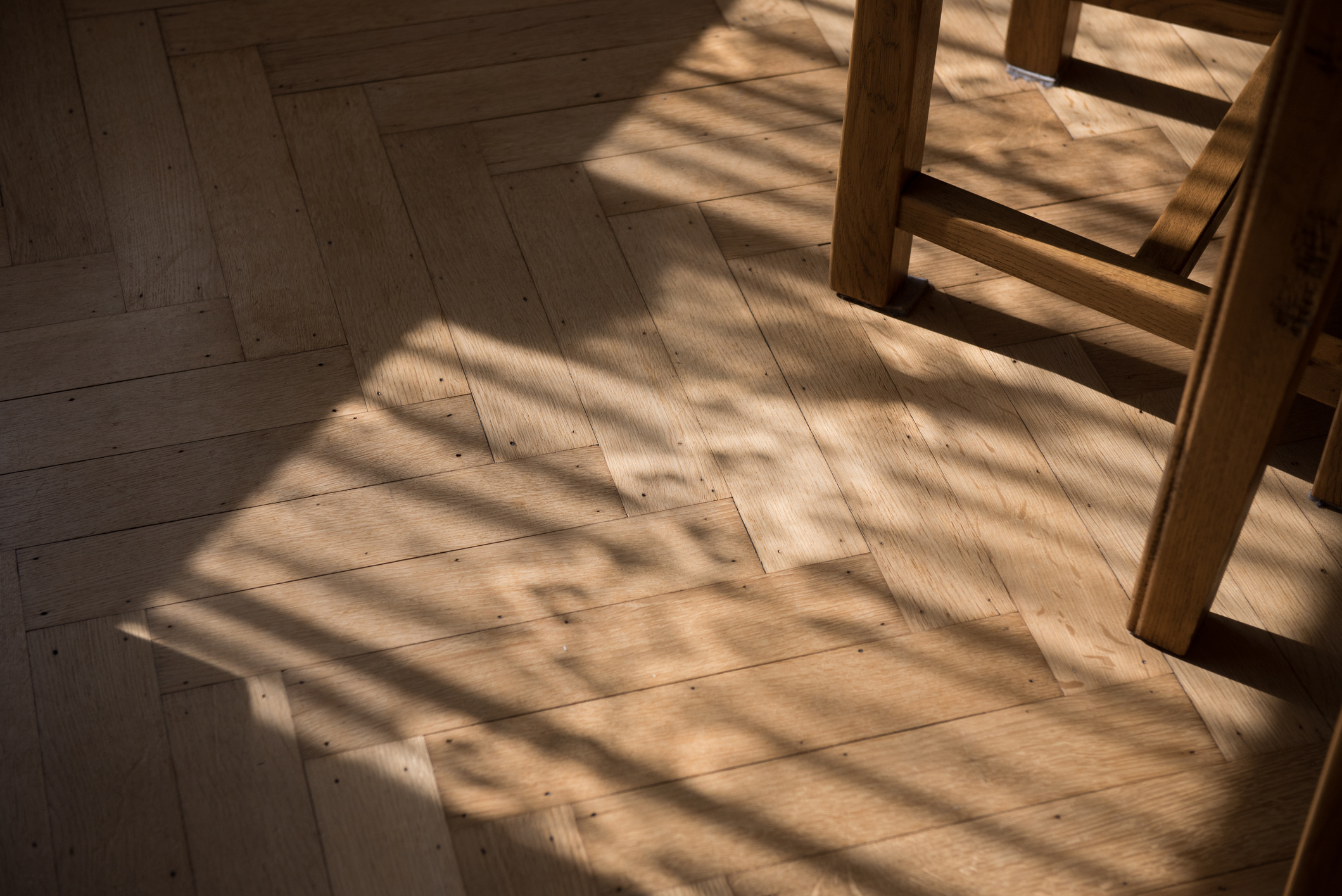 Light streams onto herringbone flooring.
