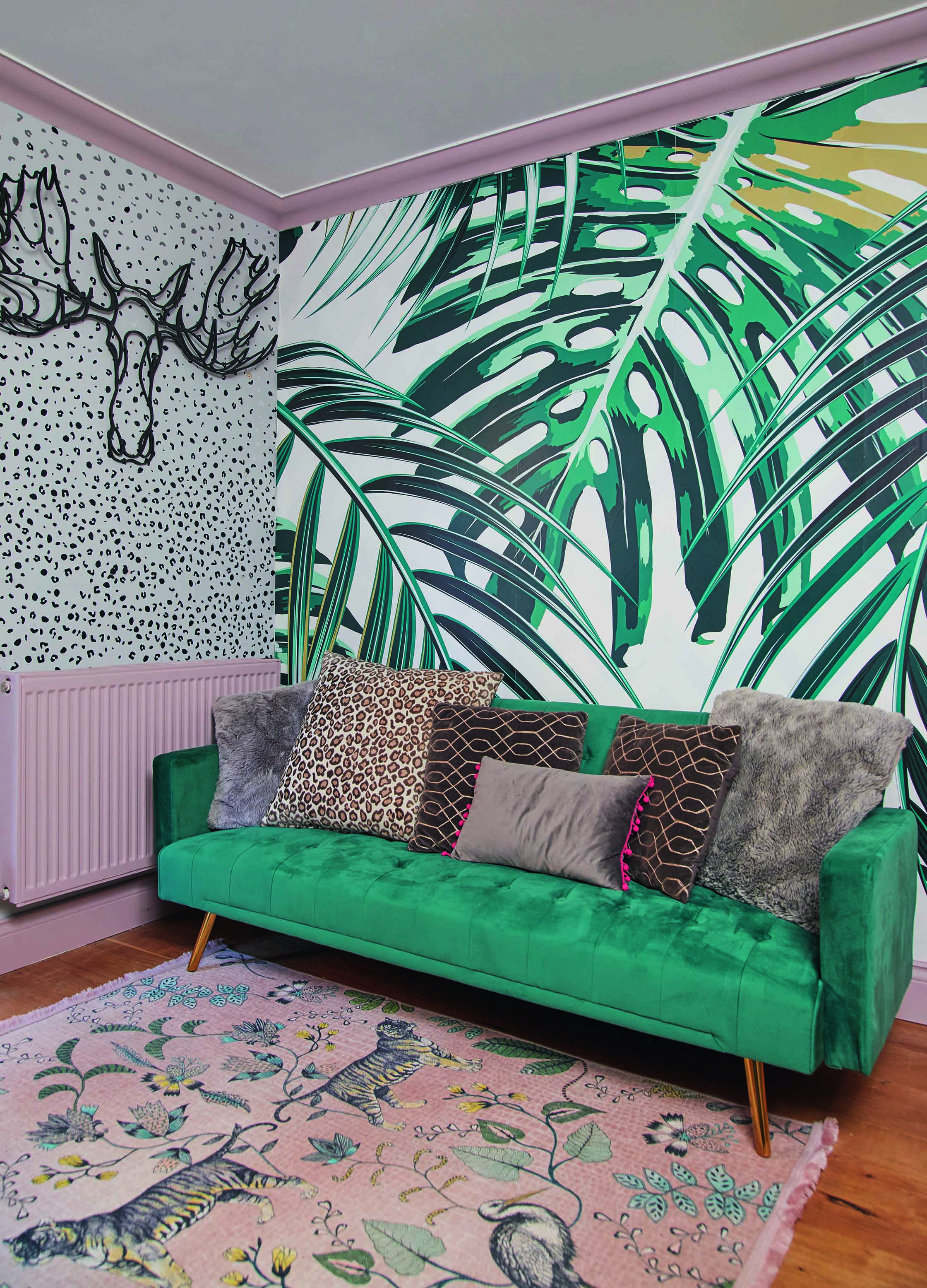 Emily's playroom features two bold wallpaper designs and a pink painted radiator