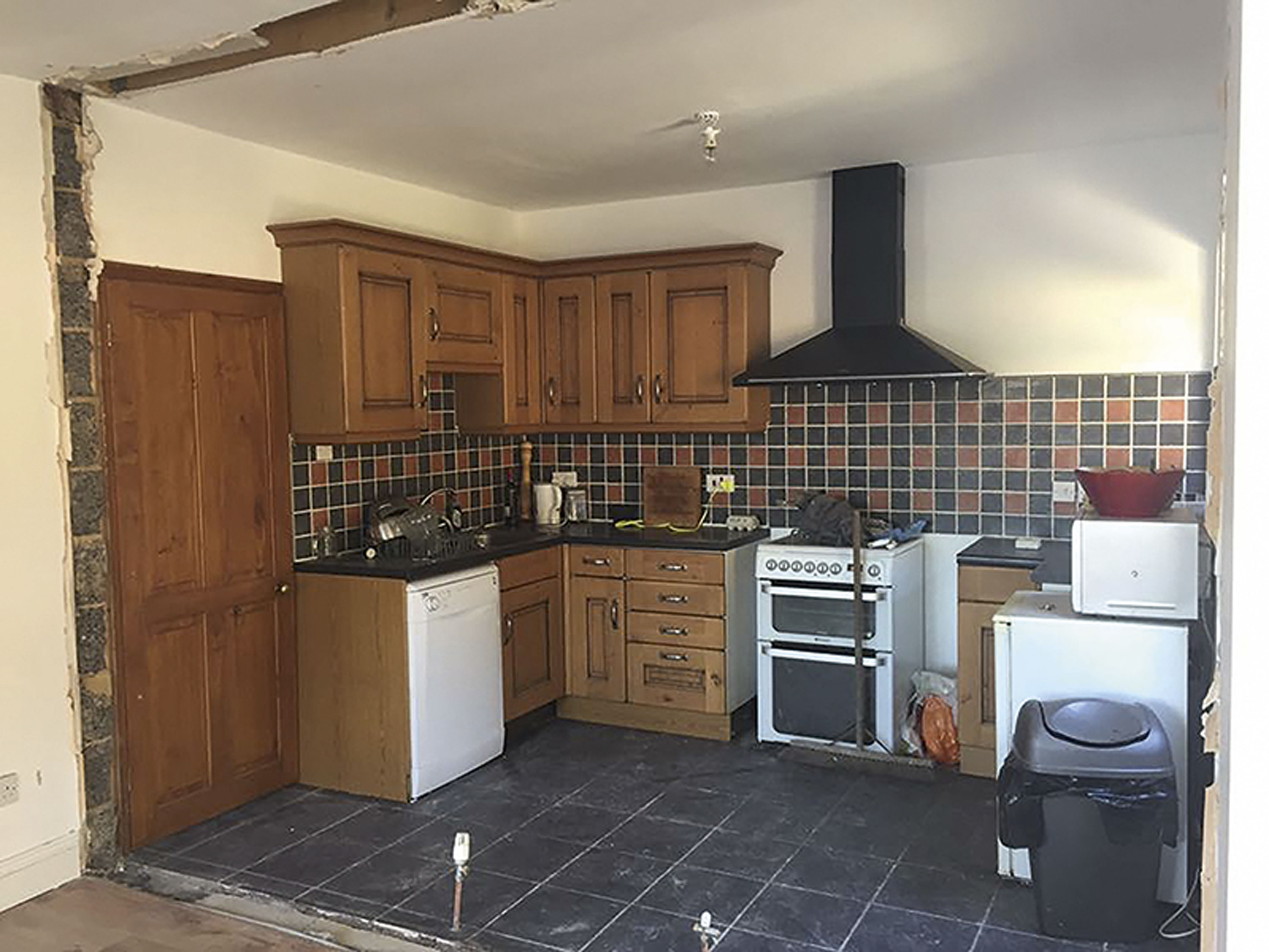 Before renovating, Greer's kitchen was much smaller, with dark wood cabinets and dark tiling