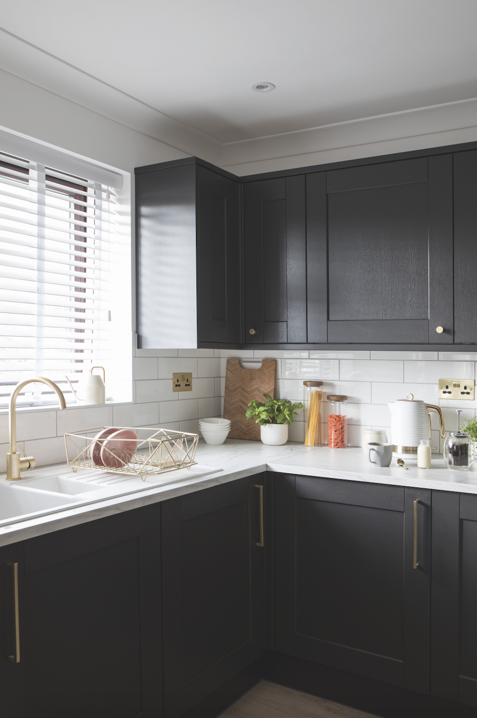Becca chose metallic fixtures and fittings to lift her dramatic dark kitchen and make it feel upscale. ‘We focused on the details, choosing a brass tap, handles and plug sockets – even the radiator has brass fittings,’ Becca explains Becca chose metallic fixtures and fittings to lift her dramatic dark kitchen and make it feel upscale. ‘We focused on the details, choosing a brass tap, handles and plug sockets – even the radiator has brass fittings,’ Becca explains