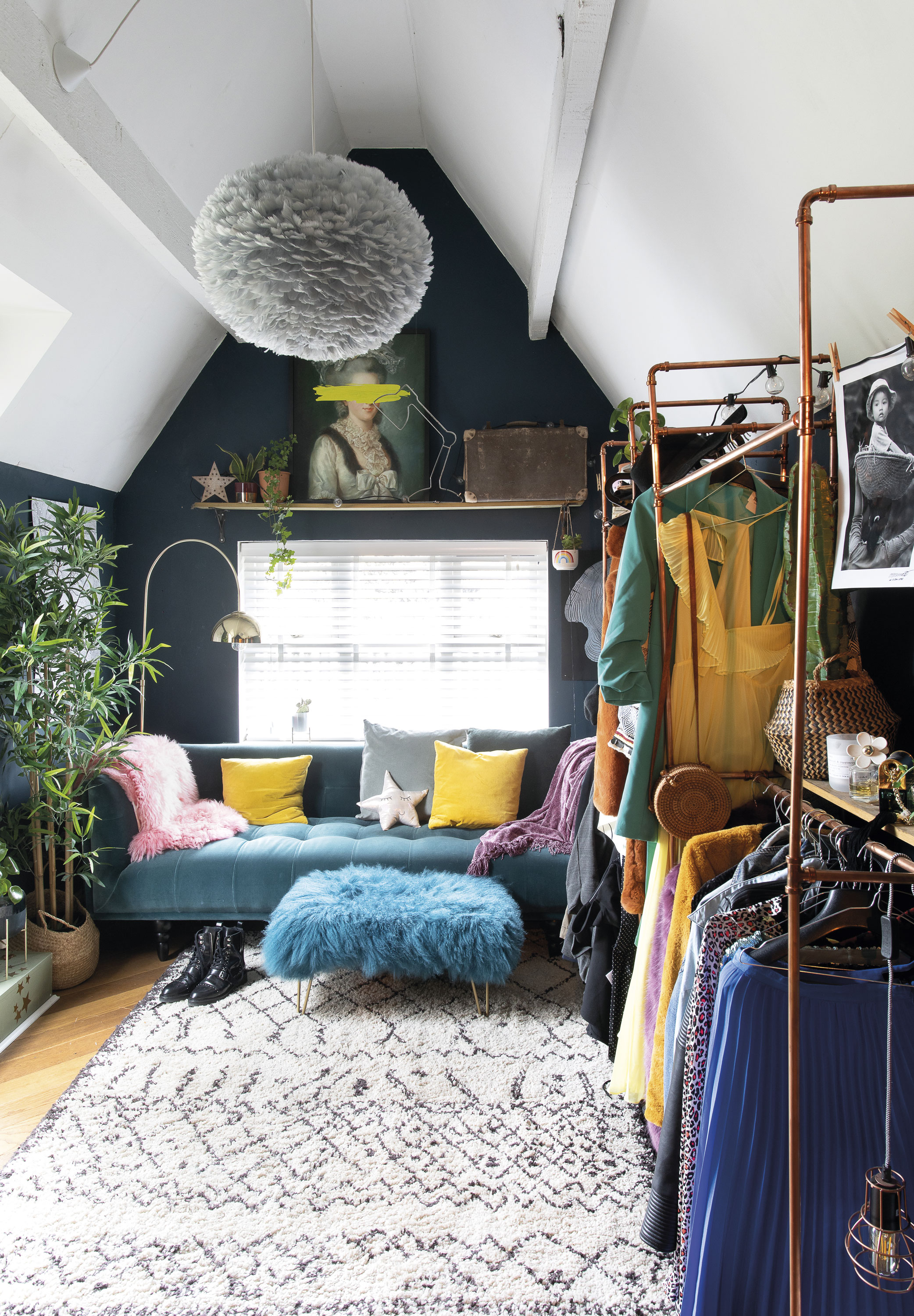 ‘Michael made the hanging rail from copper piping. I got the idea from Pinterest,’ Eniko shares. The walls are painted in Hague Blue by Farrow & Ball, and the teal sofa is from MADE, brightened up with accessories in rainbow hues ‘Michael made the hanging rail from copper piping. I got the idea from Pinterest,’ Eniko shares. The walls are painted in Hague Blue by Farrow & Ball, and the teal sofa is from MADE, brightened up with accessories in rainbow hues