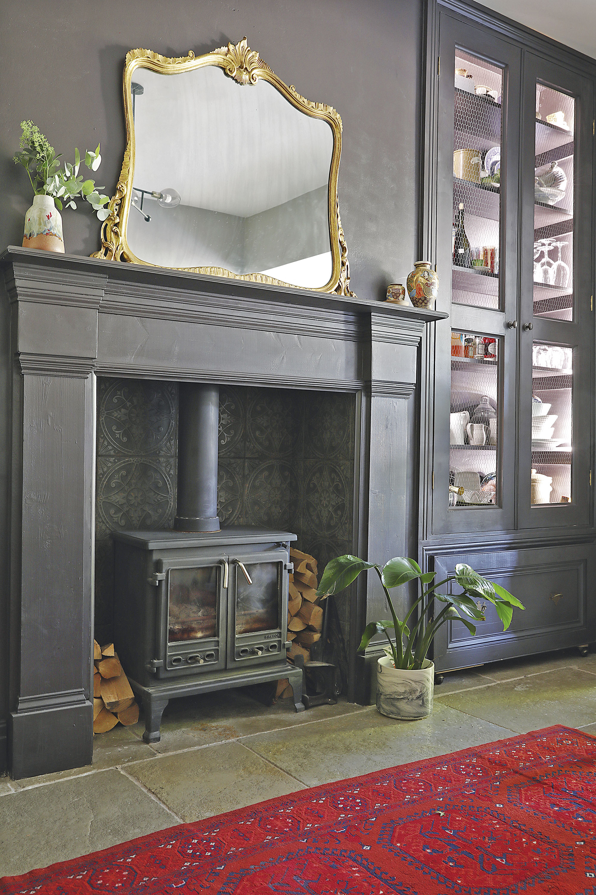Home makeover: 'Our style is a modern take on traditional' ‘The Ca’ Pietra tiles behind the new log-burner are the same as the kitchen splashback, so they link the two spaces together’