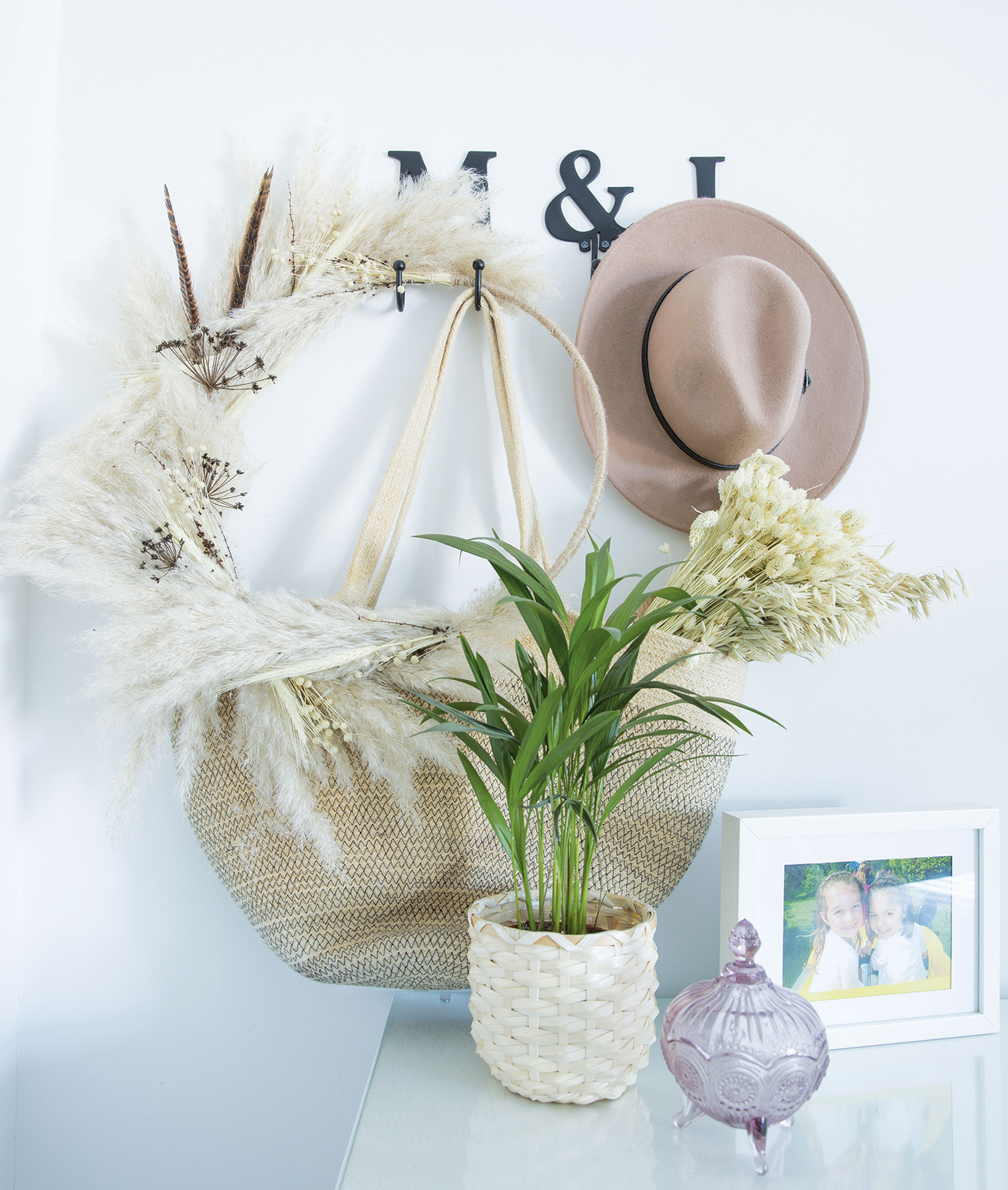 Lindsey has used personalised hooks to add interest to the wall and keep favourite accessories to hand. It’s also the perfect way to display her boho-style wreath Home makeover: 'I knew it would be the perfect home'