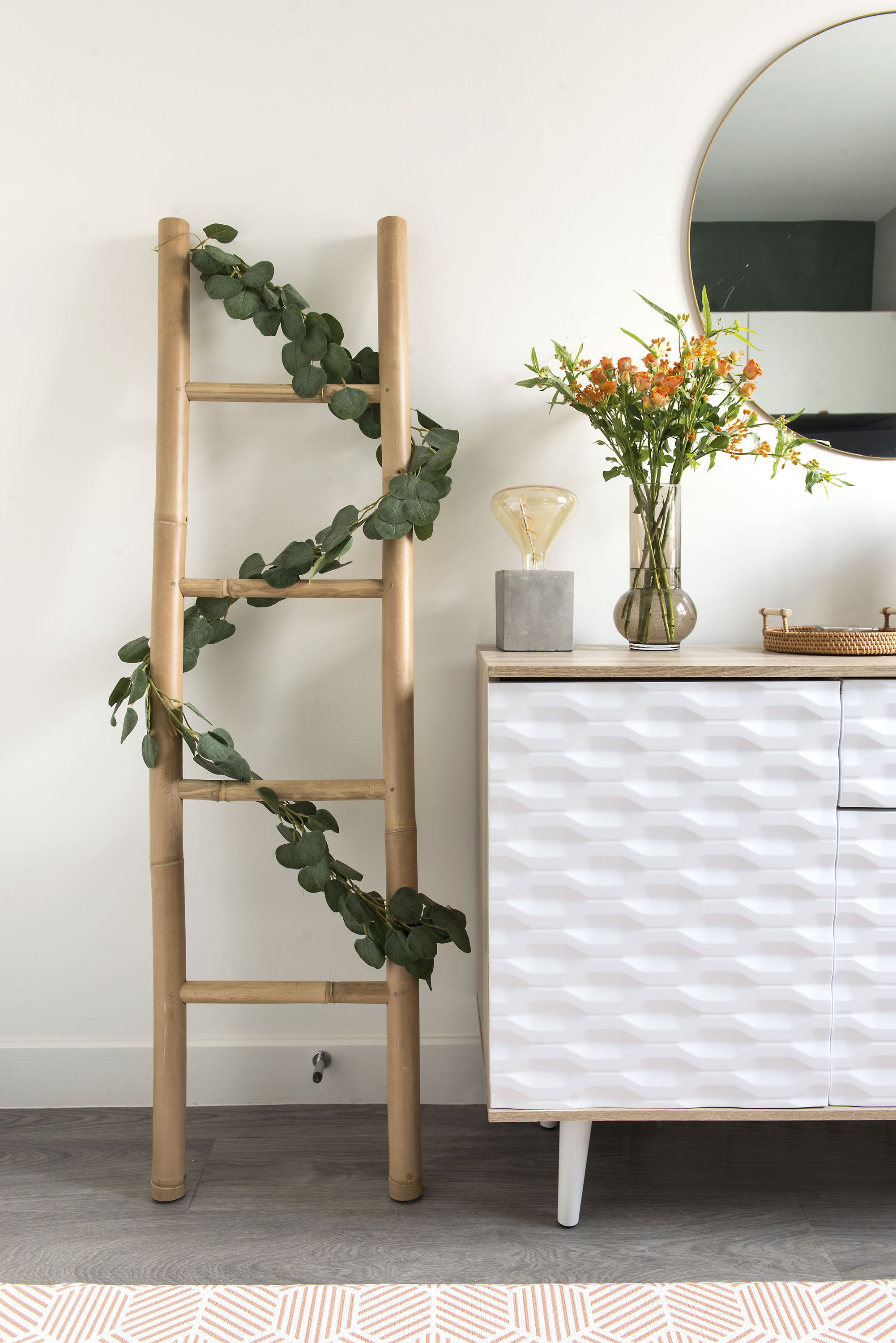 Good idea! Lydia’s bamboo ladder, trailed with faux greenery softens the room, breaks up the wall and makes an interesting decorative feature
