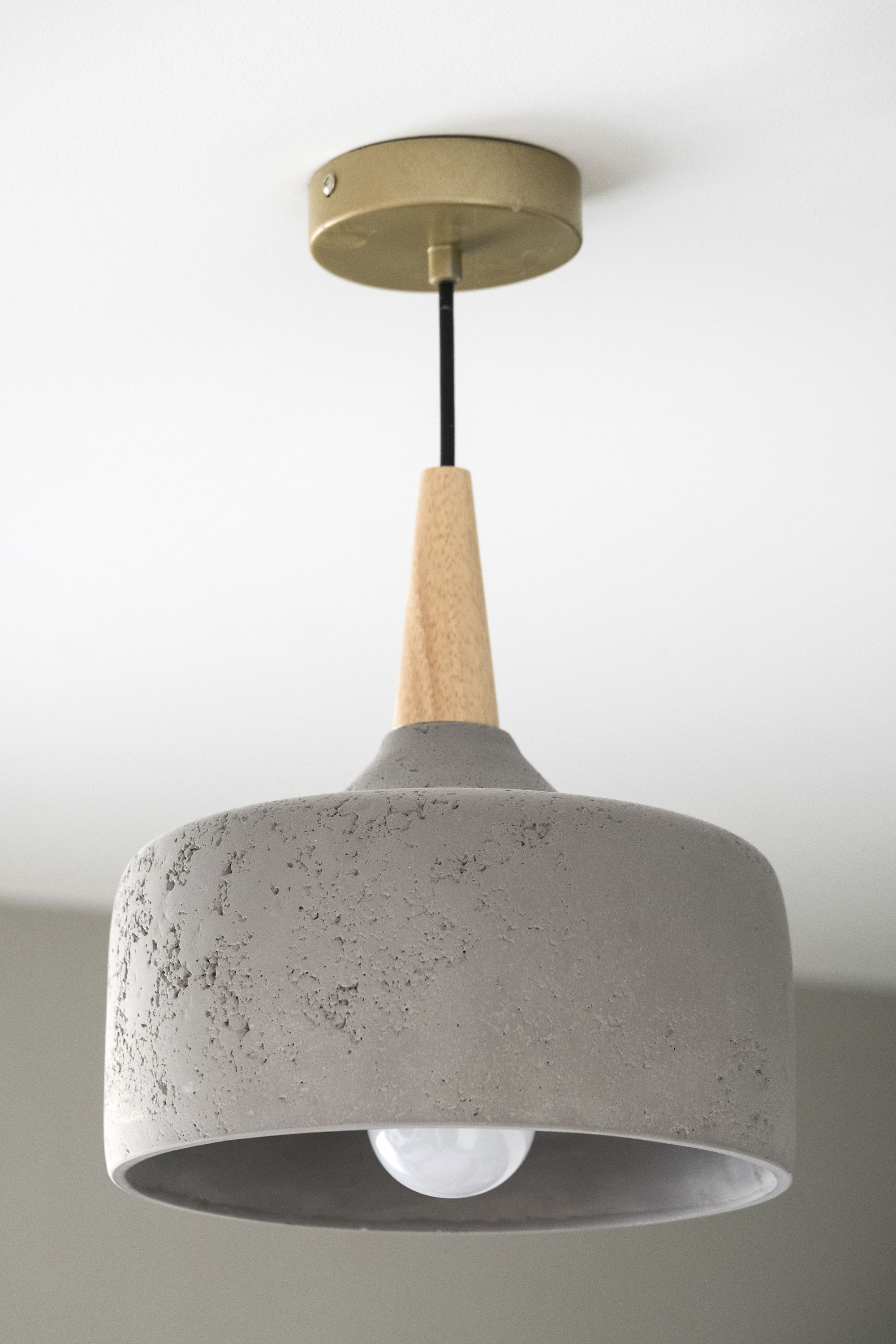 Good idea! The ceiling light’s mix of natural wood and concrete adds texture to an otherwise sleek scheme Good idea! The ceiling light’s mix of natural wood and concrete adds texture to an otherwise sleek scheme