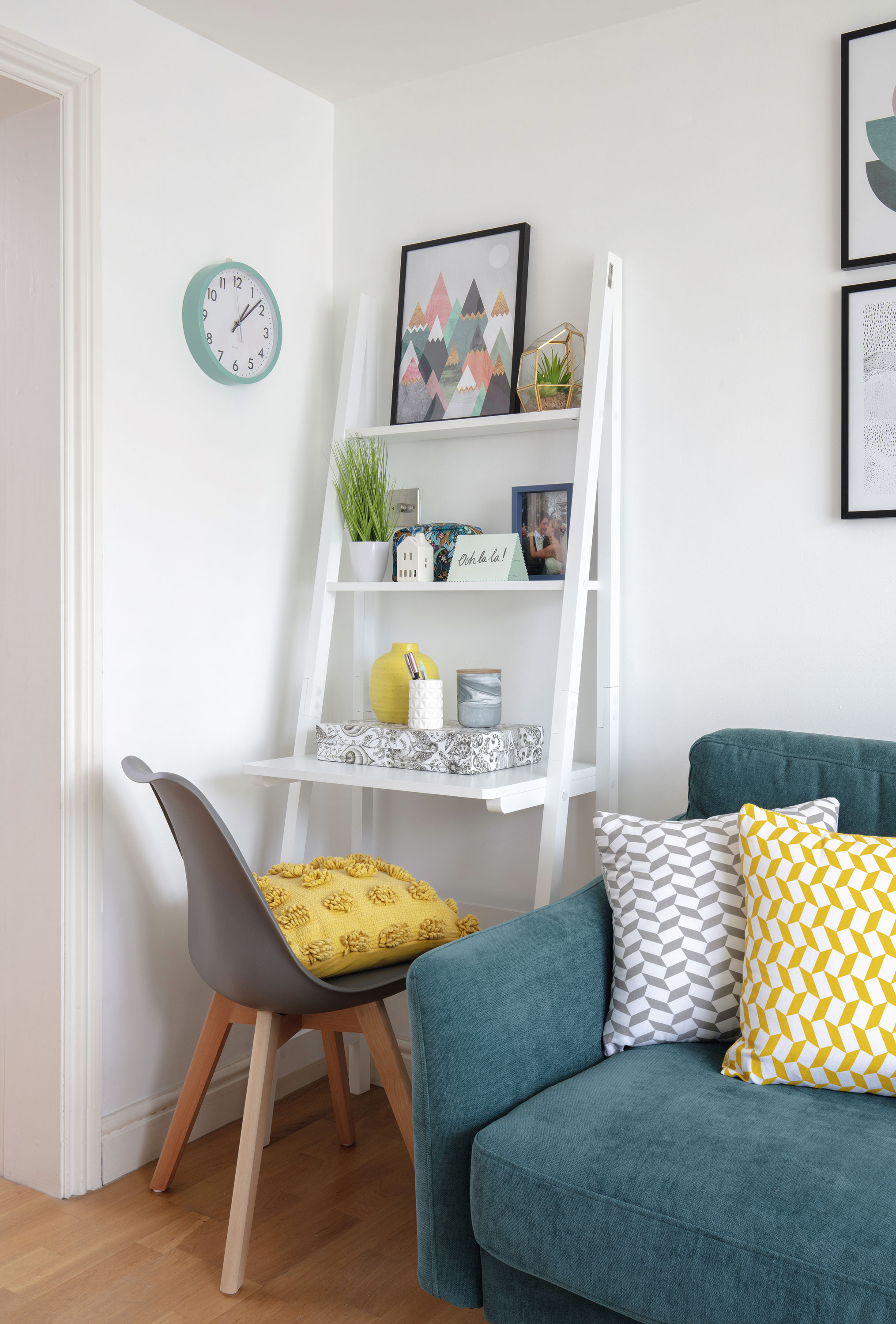It was important for Erika that she squeezed in a home office area that didn’t overtake the rest of the living room. She went for a wooden ladder-style desk from ManoMano with shelves to display family photos, art, plants and boxes for her office stationery Living room makeover: 'We were inspired by bright Scandi designs'