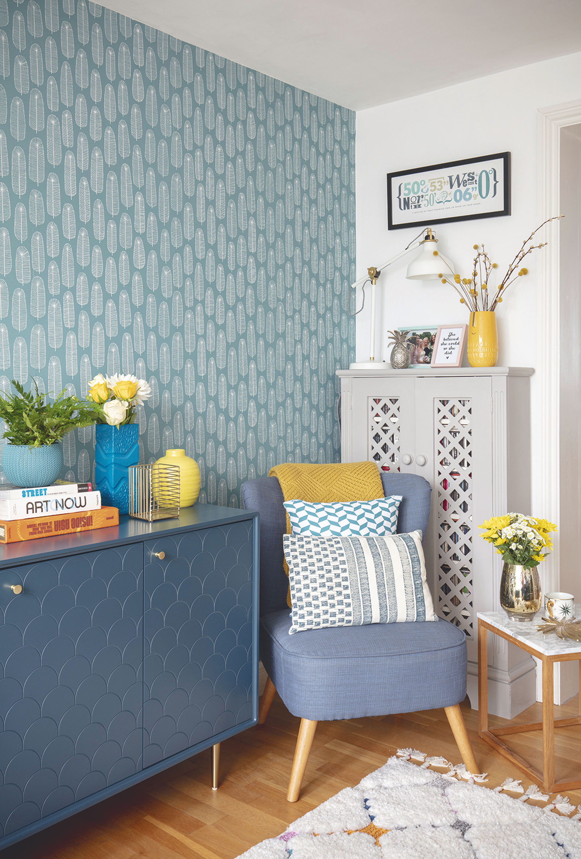 Erika has upcycled an old CD cabinet into a cupboard for her books. She has finished the cosy reading nook with an old armchair dressed with a brightly coloured throw and cushions, along with a desk lamp for reading Living room makeover: 'We were inspired by bright Scandi designs'