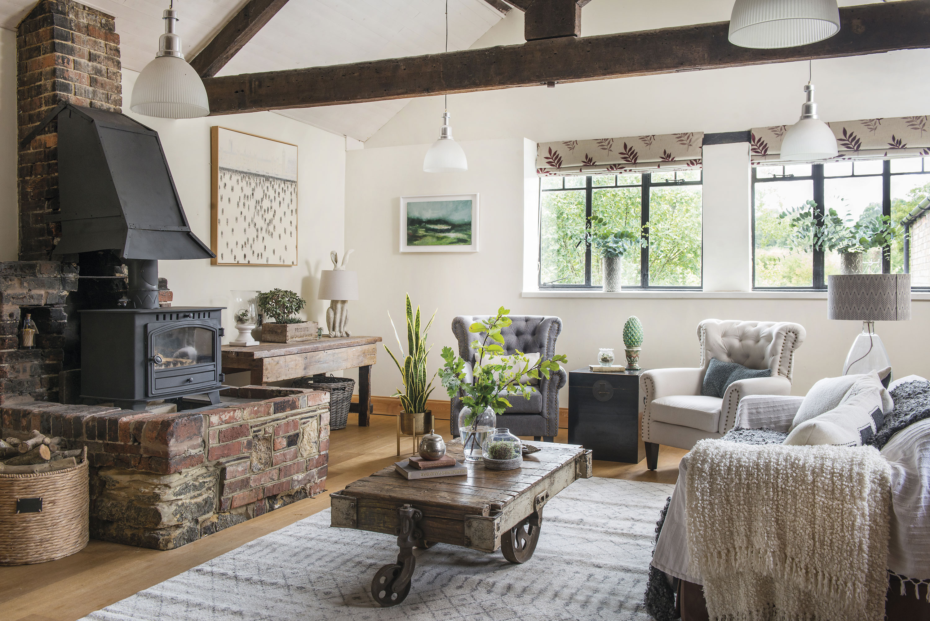 The former forge fireplace still takes centre stage in the large living room and the unusual coffee table adds to the feeling of history. ‘It’s an old trolley from America, which was used in factories to push around large items of furniture or to collect nuts. We found it in a great place called Room Seven Interiors in Rye, Sussex, and owner Angela Bunyan told us the story.’ The former forge fireplace still takes centre stage in the large living room and the unusual coffee table adds to the feeling of history. ‘It’s an old trolley from America, which was used in factories to push around large items of furniture or to collect nuts. We found it in a great place called Room Seven Interiors in Rye, Sussex, and owner Angela Bunyan told us the story.’