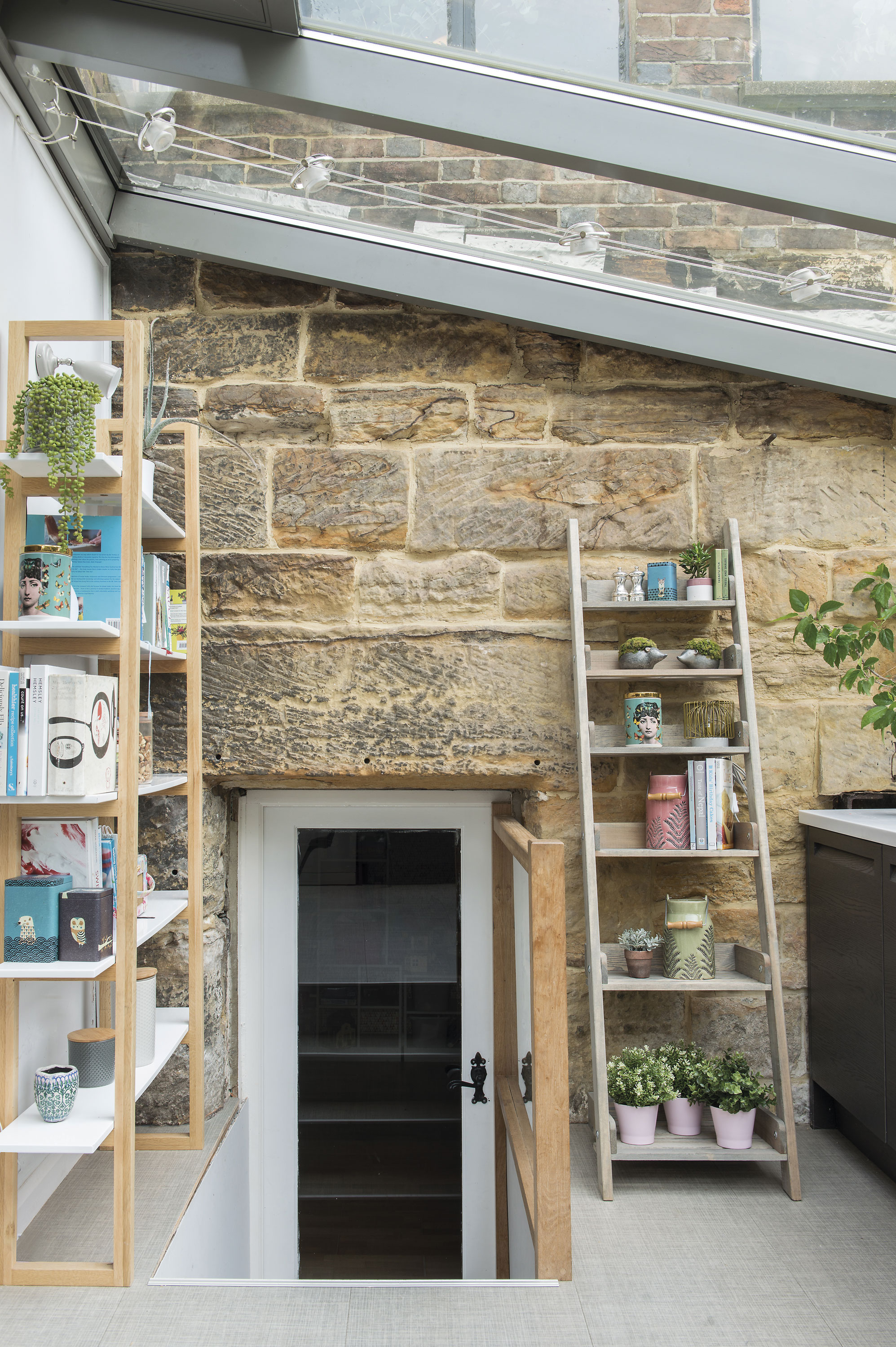 A light-filled space with a glass roof makes the most of the exposed wall in the kitchen. The basement extension was added by previous owners, with access onto the garden on the lower level A light-filled space with a glass roof makes the most of the exposed wall in the kitchen. The basement extension was added by previous owners, with access onto the garden on the lower level