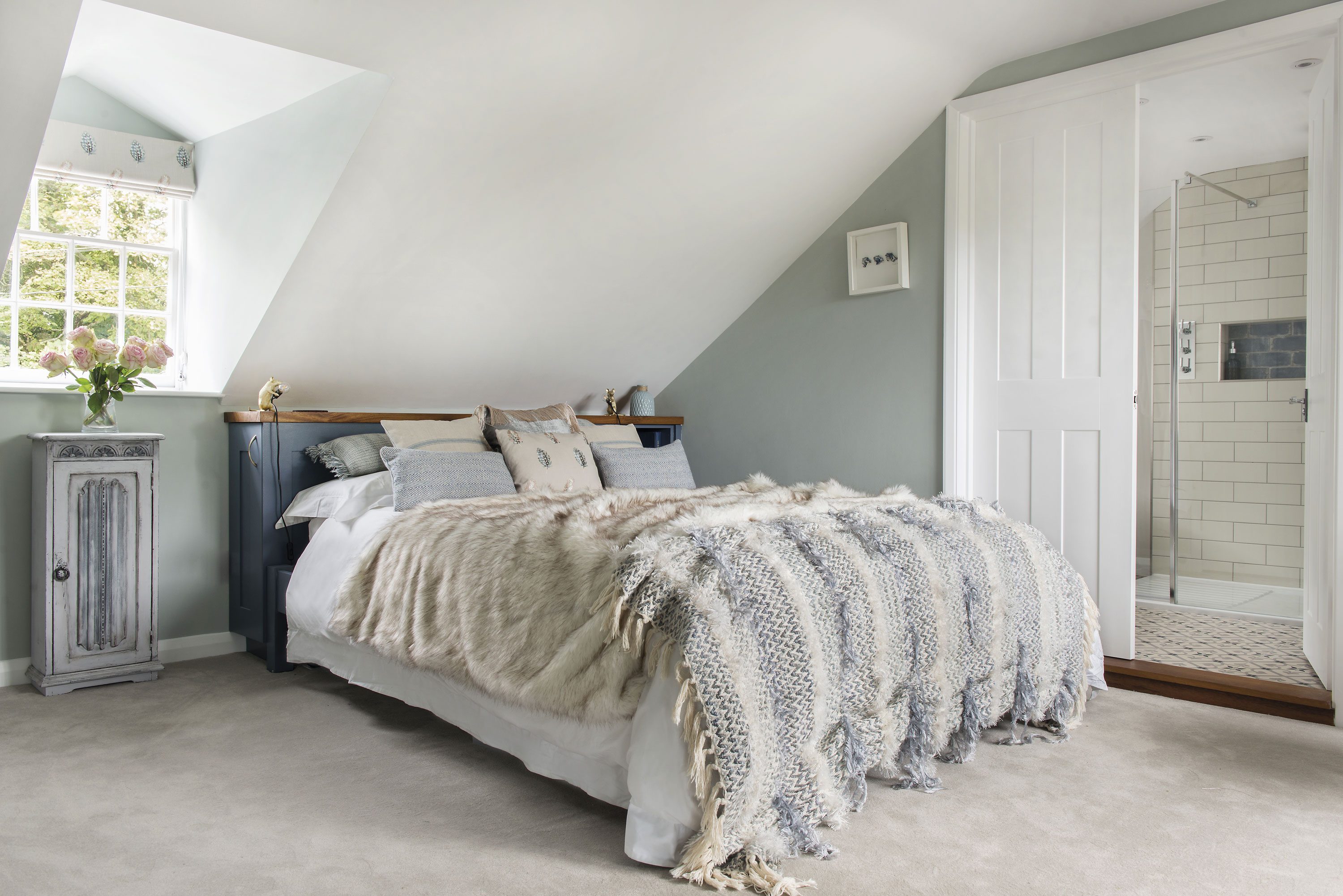 In the main bedroom in the loft, Charlie has painted the walls in a grey by Paint & Paper Library and, for a touch of fun, she’s added some gold mouse lamps to the headboard, both by Graham & Green