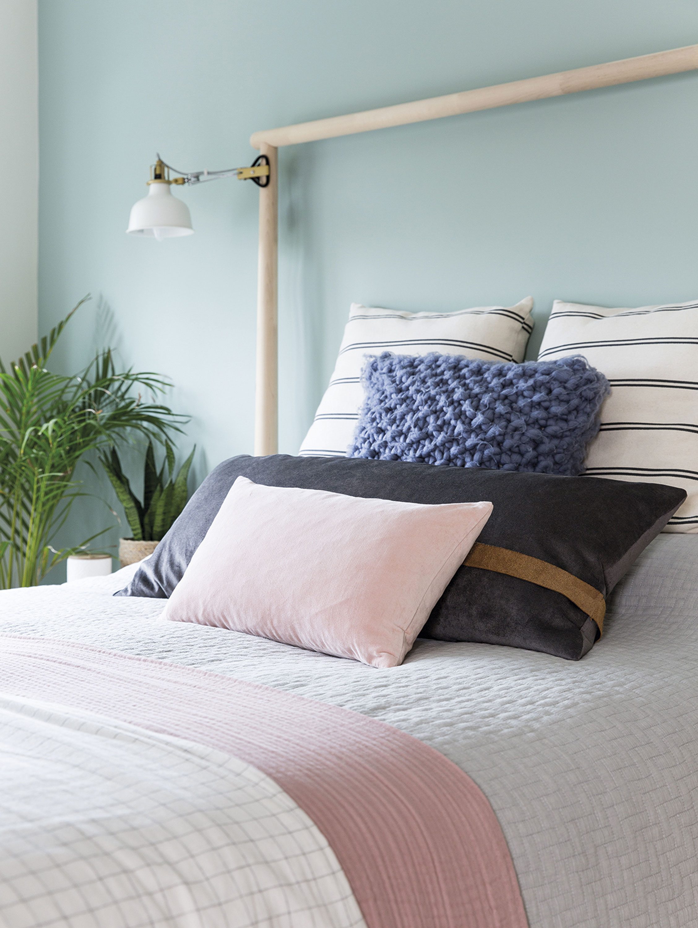 Layering up cushions, blankets and waffle bed linen in different tones and textures brings the bed to life, while a mix of fresh and faux plants helps to soften the space Layering up cushions, blankets and waffle bed linen in different tones and textures brings the bed to life, while a mix of fresh and faux plants helps to soften the space