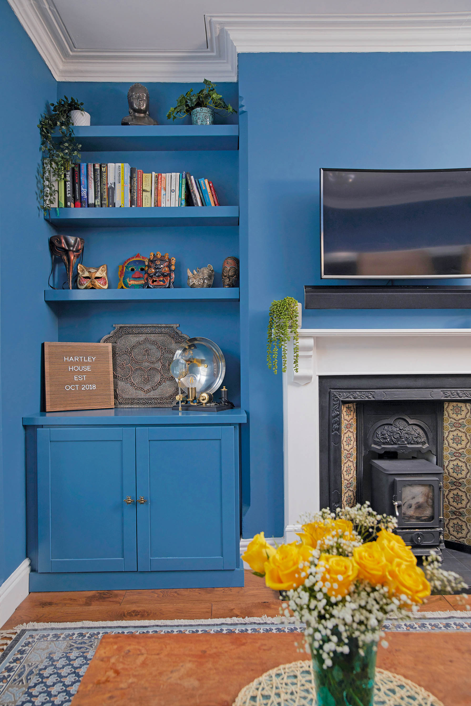 ‘Painting the wall and shelves the same colour has given the room a consistent feel, but it also feels more spacious and sophisticated. I’m glad that we kept this as a formal living room, as at one point we discussed knocking through to include a dining area. We made the masks while travelling in Venice and the Hartley House sign is a letter board’